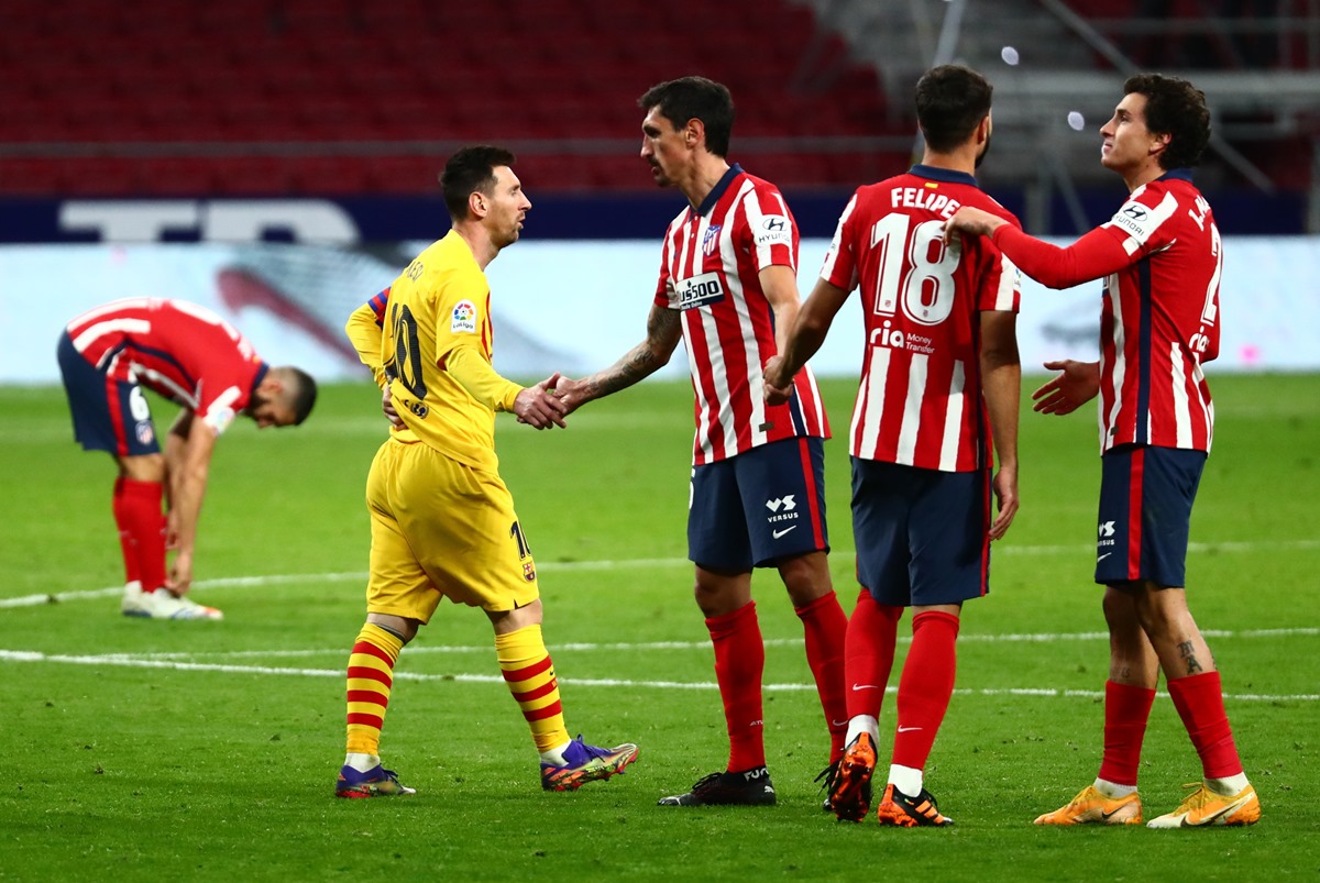 Soccer Football - La Liga Santander - Atletico Madrid v FC Barcelona - Wanda Metropolitano, Madrid, Spain - November 21, 2020 Barcelona's Lionel Messi shakes hands with Atletico Madrid's Stefan Savic at the end of the match REUTERS