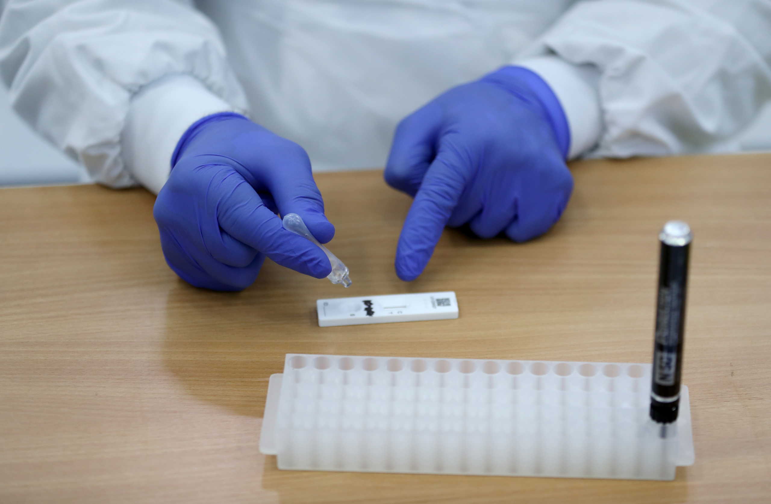 An employee attends testing of a lateral flow antigen test facility, amid the spread of the coronavirus disease (COVID-19), in St Andrews, Scotland, Britain, November 27, 2020. REUTERS