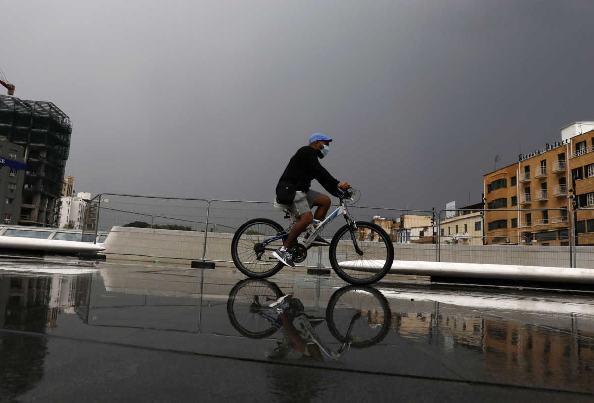 A man wearing a protective face mask rides his bicycle amid the coronavirus disease (COVID-19) pandemic, in Nicosia, Cyprus November 11, 2020. REUTERS