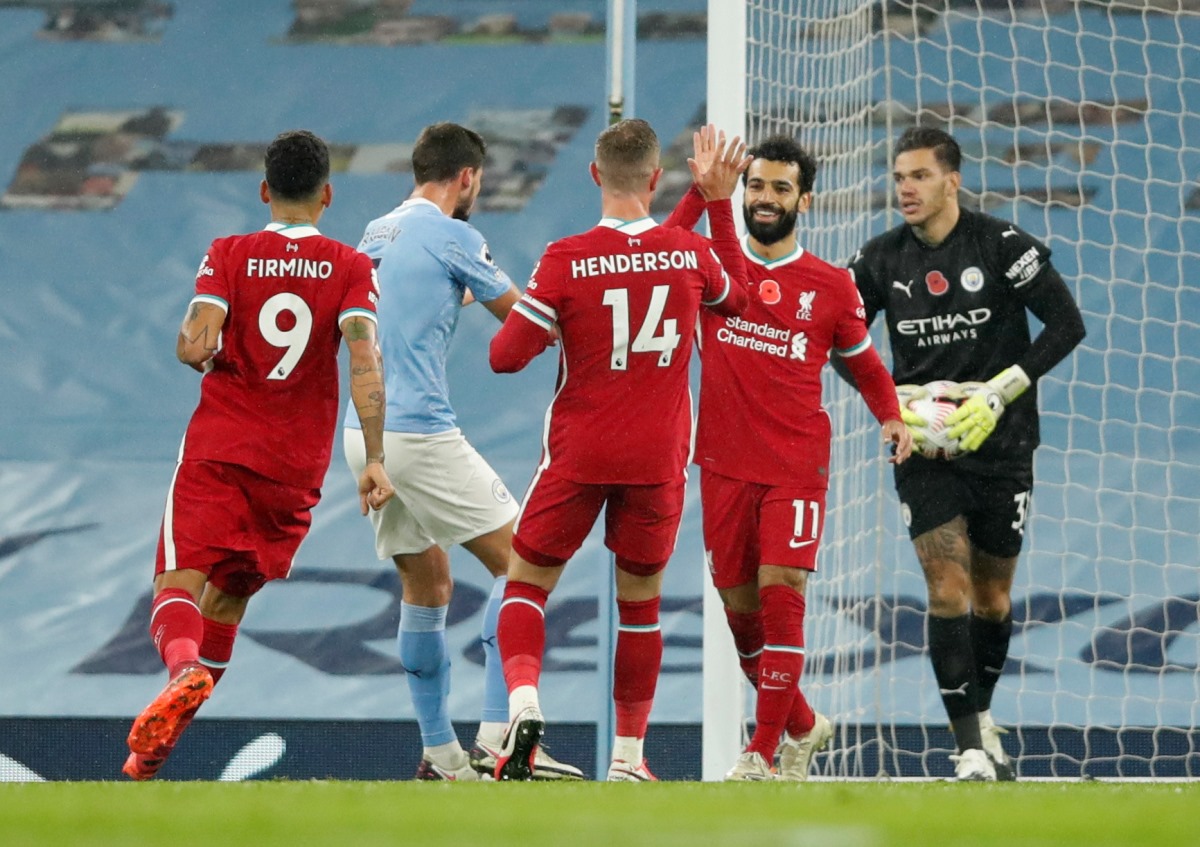 Soccer Football - Premier League - Manchester City v Liverpool - Etihad Stadium, Manchester, Britain - November 8, 2020 Liverpool's Mohamed Salah celebrates scoring their first goal with teammates Pool via REUTERS