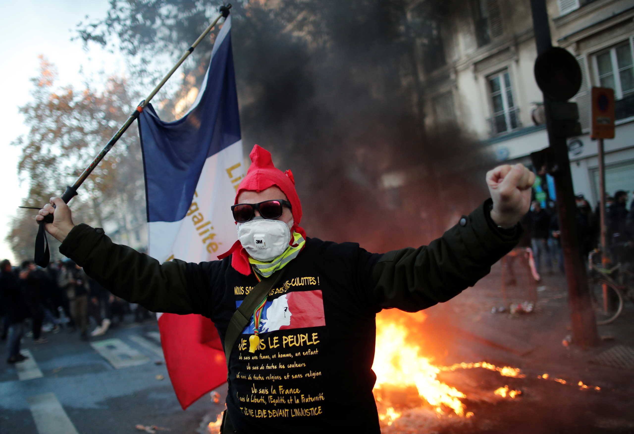 People take part in a demonstration against the "Global Security Bill' that rights groups say would make it a crime to circulate an image of a police officer's face and would infringe journalists' freedom in France, in Paris, November 28, 2020. REUTERS