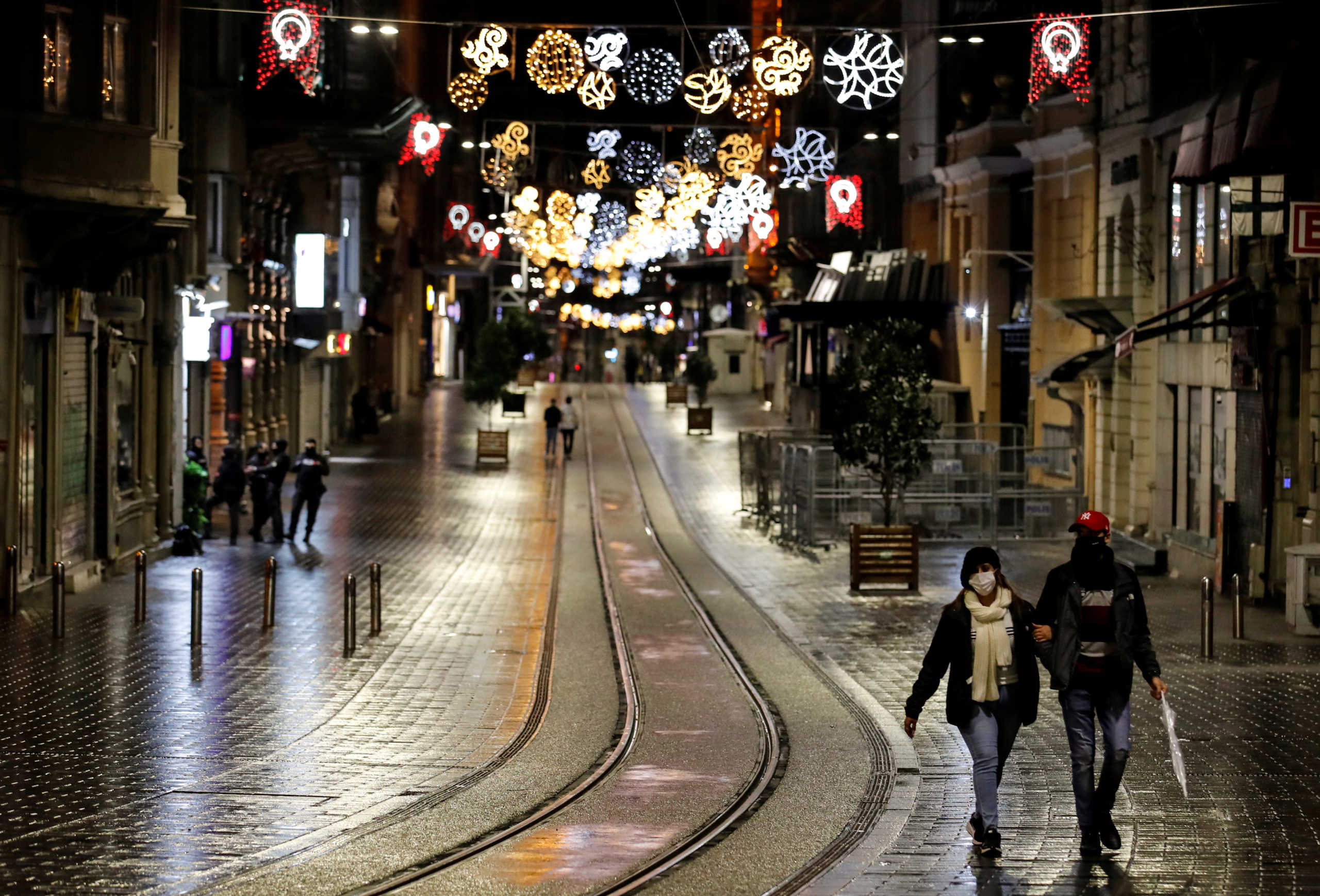 FILE PHOTO: Couple walks along Istiklal Street at the popular touristic neighbourhood of Beyoglu after a partial weekend curfew started during the COVID-19 outbreak in Istanbul, Turkey, November 21, 2020. REUTERS