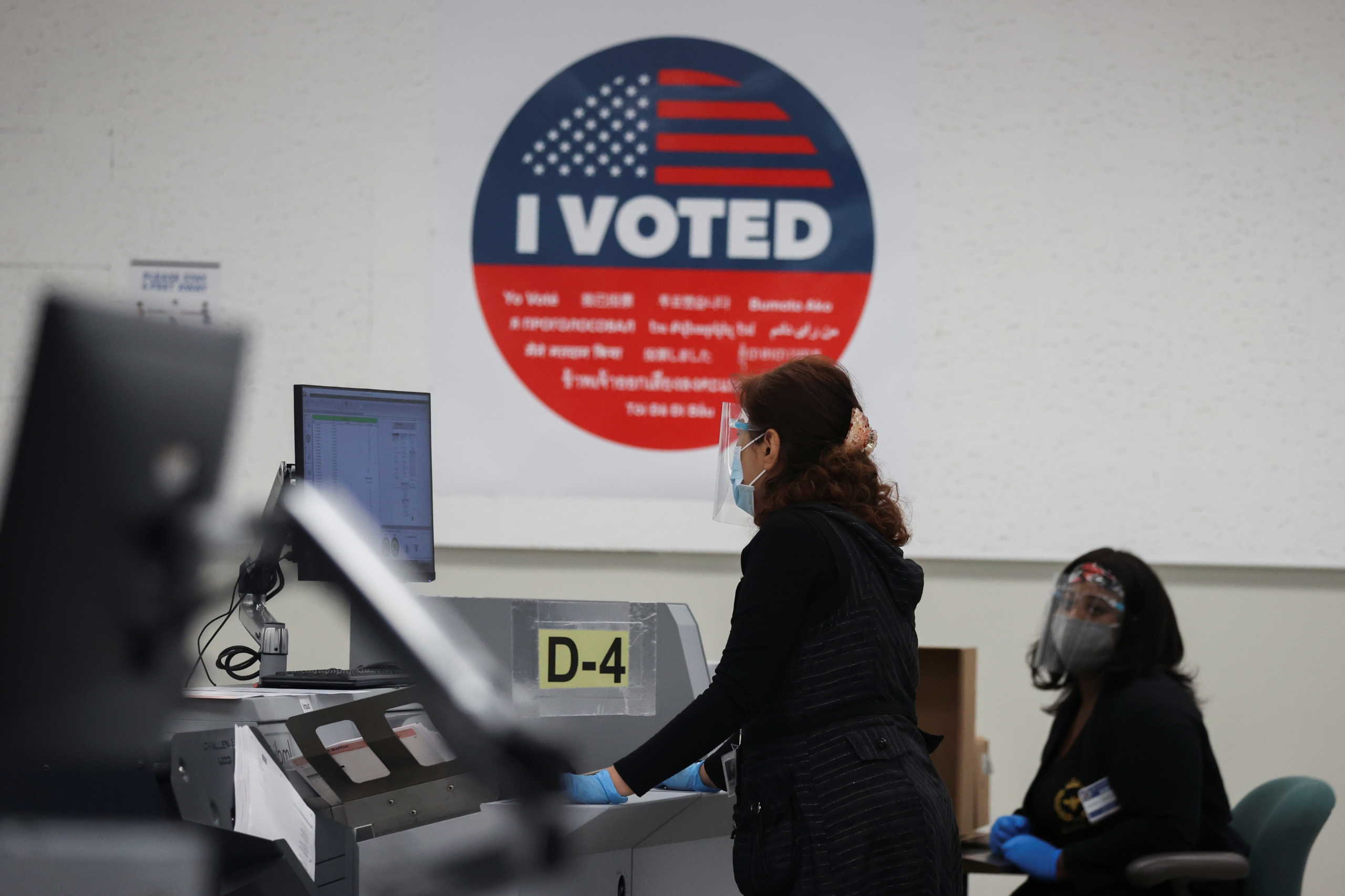 People count postal ballots following the 2020 U.S. presidential election, in Downey, near Los Angeles, California, U.S., November 5, 2020. REUTERS