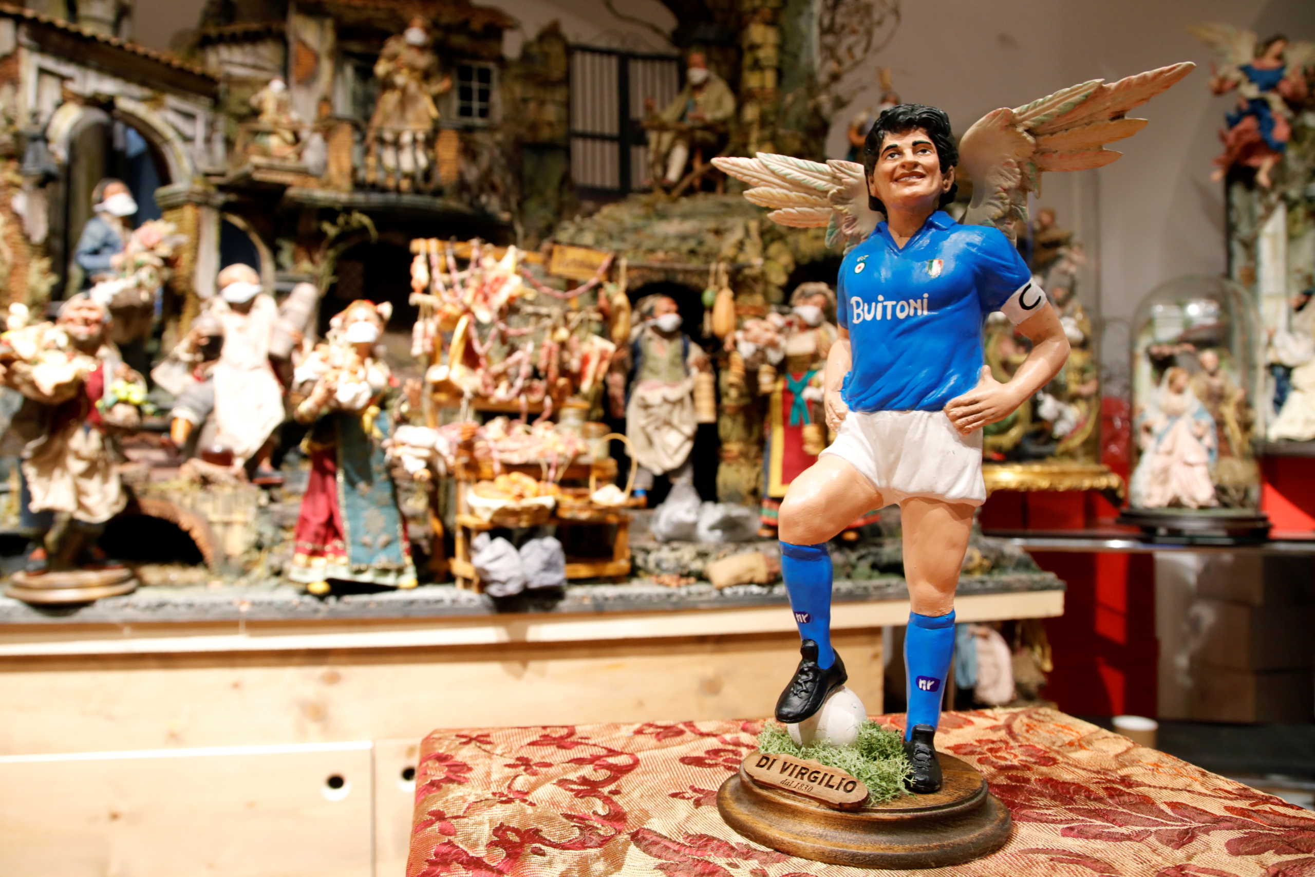 A figurine depicting late soccer legend Diego Maradona with angel wings is pictured the day after his death at a shop on Via San Gregorio Armeno, the famous street in Naples dedicated to producing nativity figurines, in Naples, Italy, November 26, 2020. REUTERS