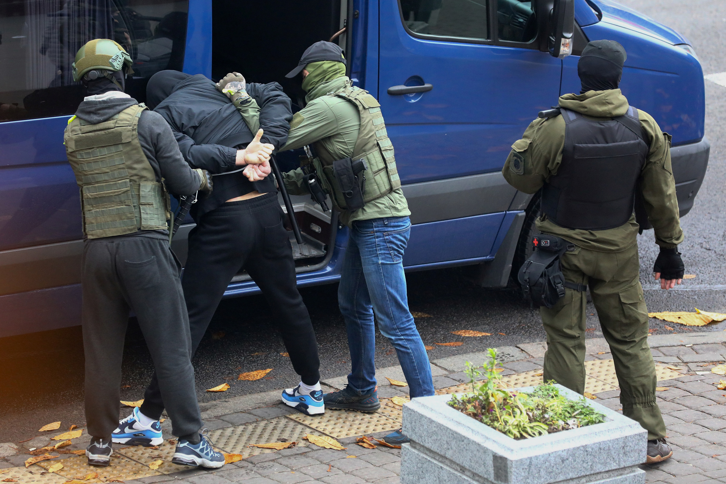 A man is detained by unidentified people, who are presumably Belarusian law enforcement officers, during a rally to reject the presidential election results in Minsk, Belarus November 8, 2020. REUTERS