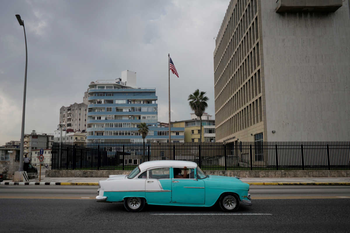 FILE PHOTO: A vintage car passes by the U.S. Embassy in Havana, Cuba, October 30, 2020. Picture taken October 30, 2020. REUTERS