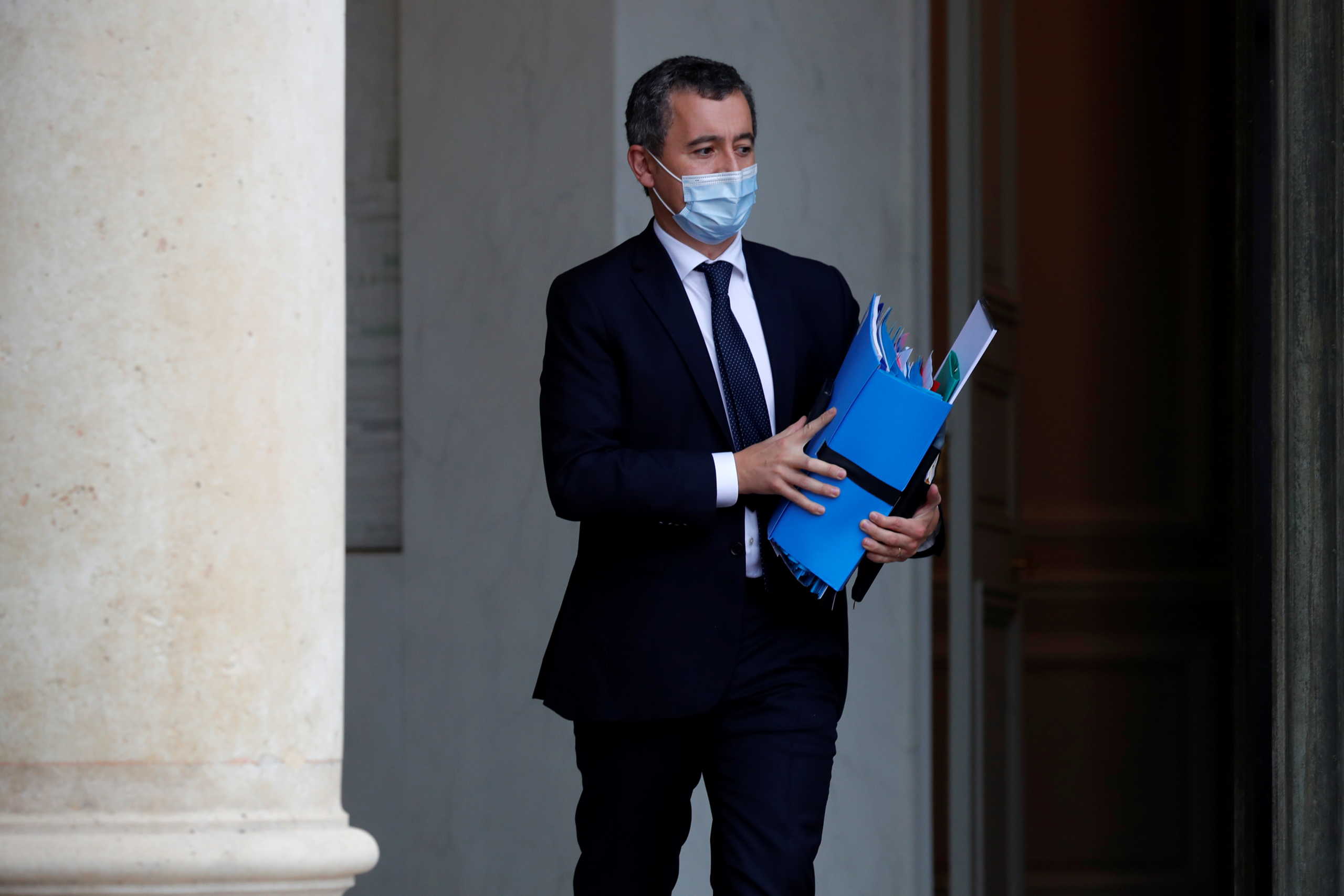 French Interior Minister Gerald Darmanin, wearing a protective face mask, leaves following the weekly cabinet meeting at the Elysee Palace in Paris, France, October 28, 2020. REUTERS