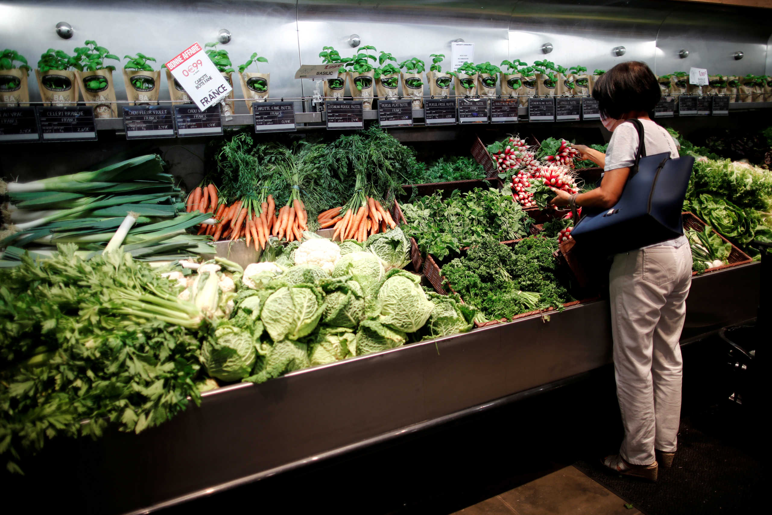 FILE PHOTO: A customer browses products inside a Monoprix supermarket operated by Casino Group, following the outbreak of the coronavirus disease (COVID-19), in Paris, France August 7, 2020. REUTERS