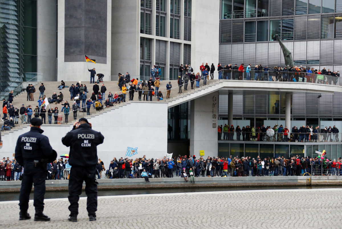 Demonstrators protest against the government's coronavirus disease (COVID-19) restrictions next to the Reichstag, the seat of Germany's lower house of parliament Bundestag, in Berlin, November, 18, 2020. REUTERS