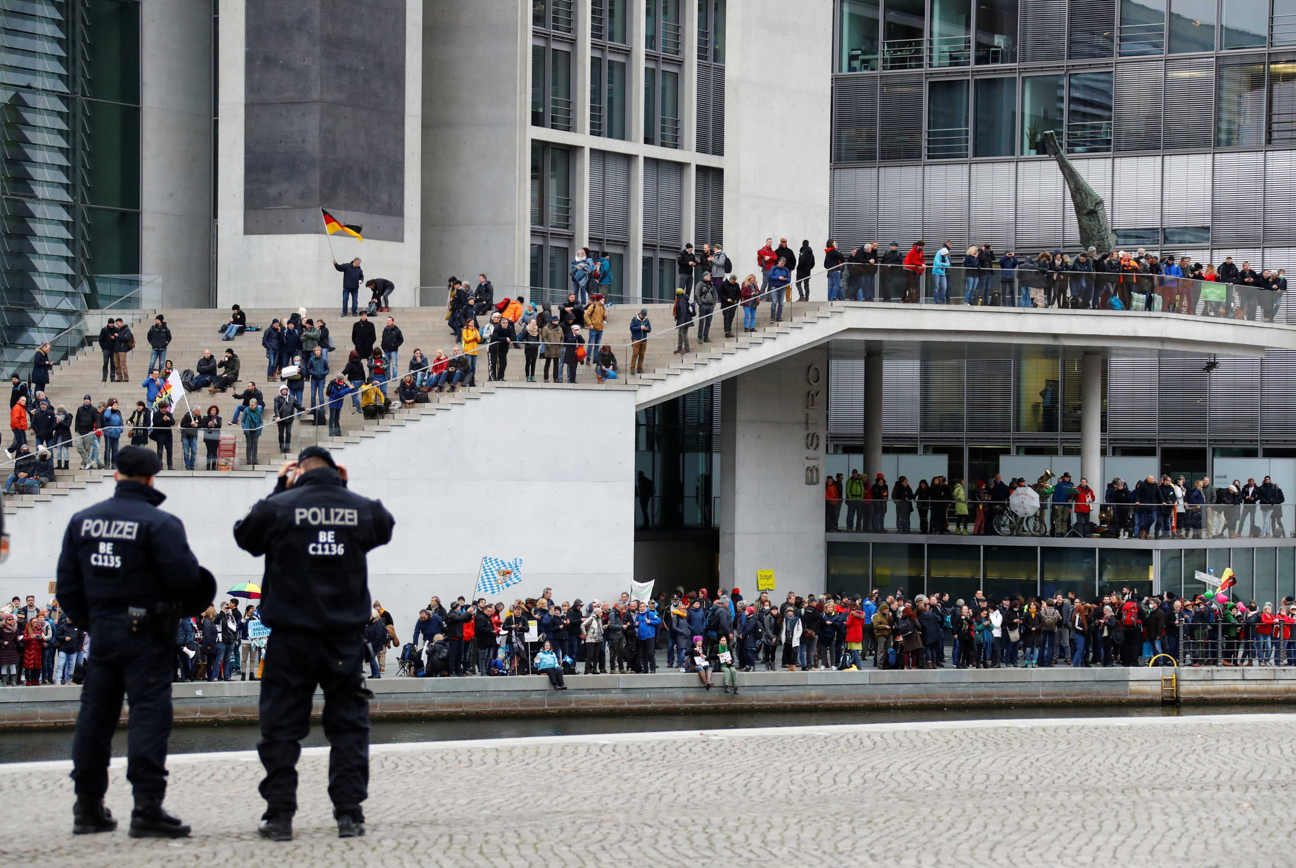 Demonstrators protest against the government's coronavirus disease (COVID-19) restrictions next to the Reichstag, the seat of Germany's lower house of parliament Bundestag, in Berlin, November, 18, 2020. REUTERS
