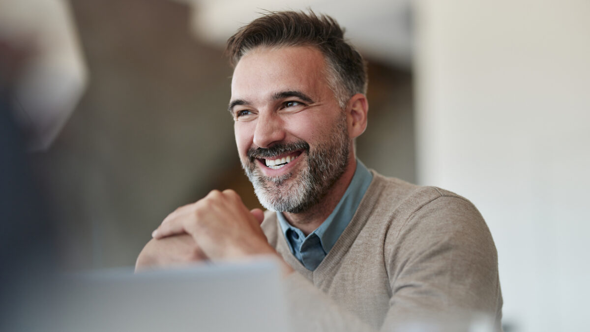 Top view of diverse business group in office meeting, collaborating and discussing around a large table.