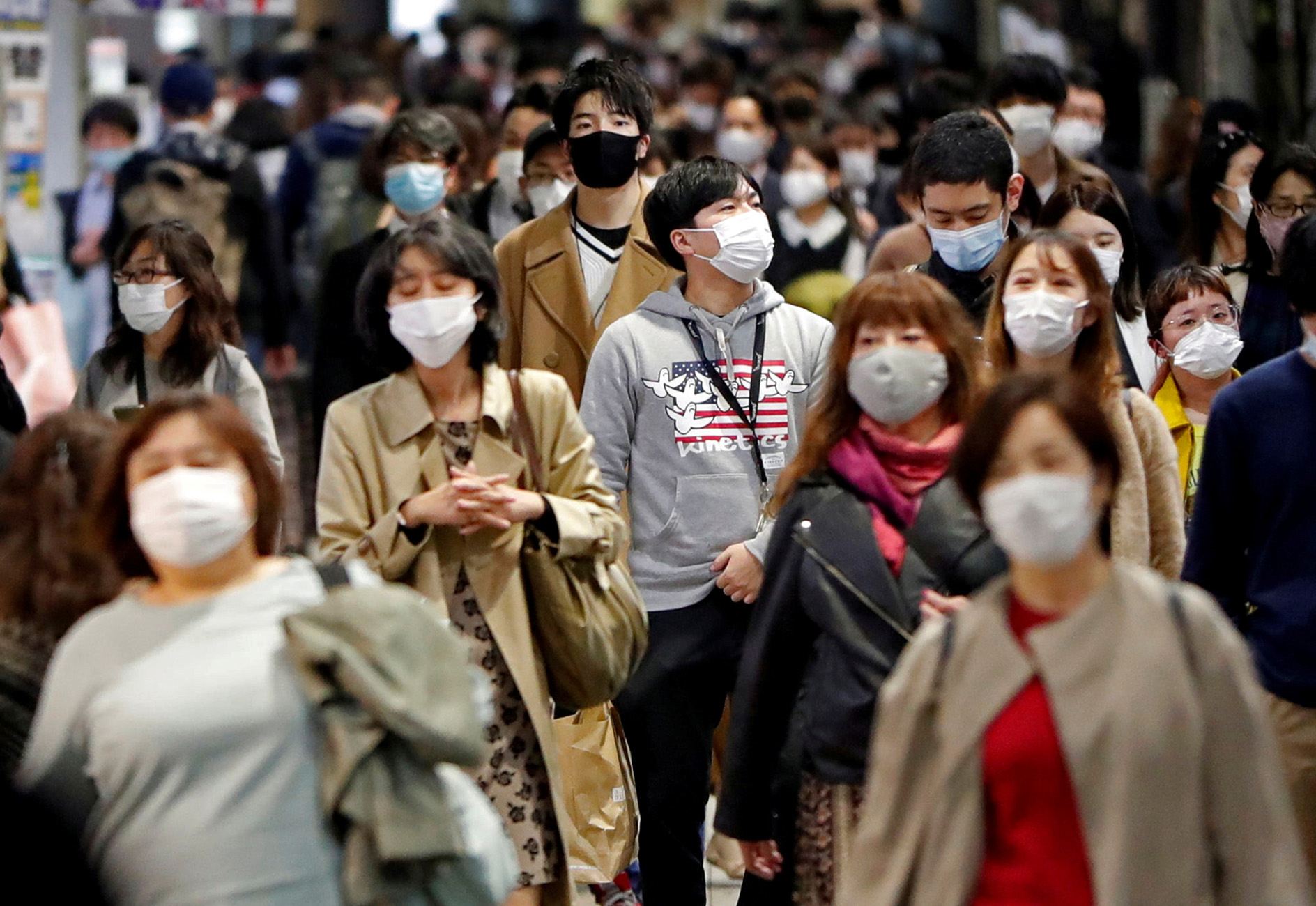 FILE PHOTO: People wearing protective face masks walk on the street, amid the coronavirus disease (COVID-19) outbreak, in Tokyo, Japan November 19, 2020. REUTERS