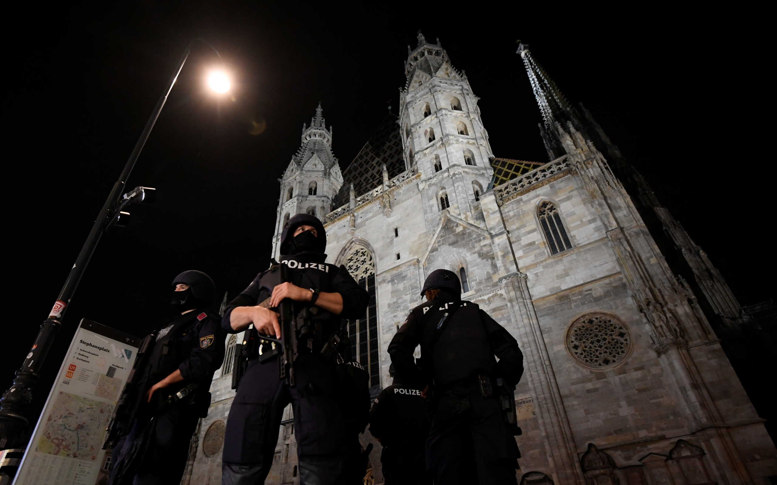 Police stand guard outside St. Stephen's cathedral, following a religious mass for the victims of a gun attack in Vienna, Austria, November 3, 2020. REUTERS