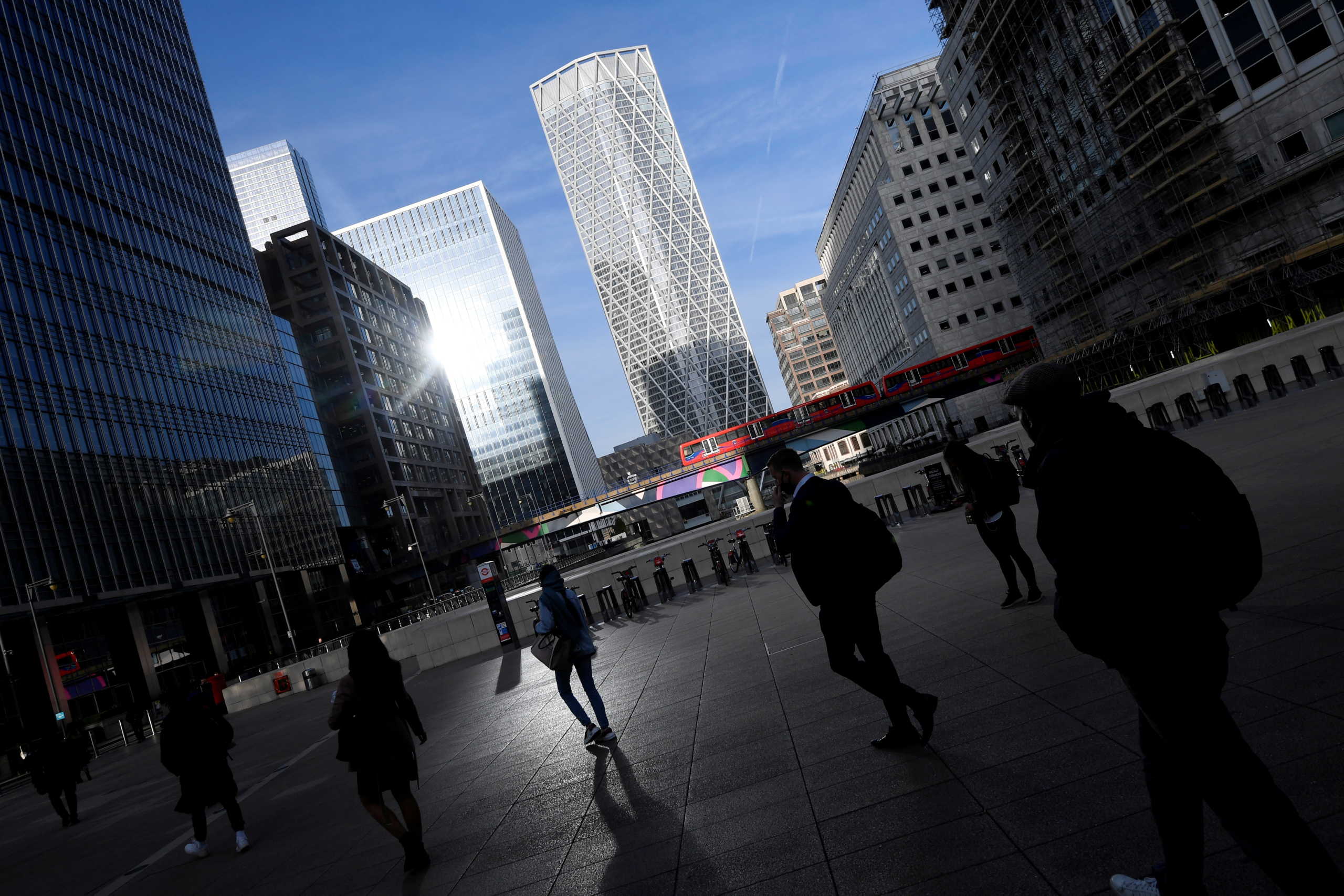 FILE PHOTO: People walk during the morning rush hour in the financial district of Canary Wharf amid the outbreak of the coronavirus disease (COVID-19) in London, Britain September 28, 2020. REUTERS