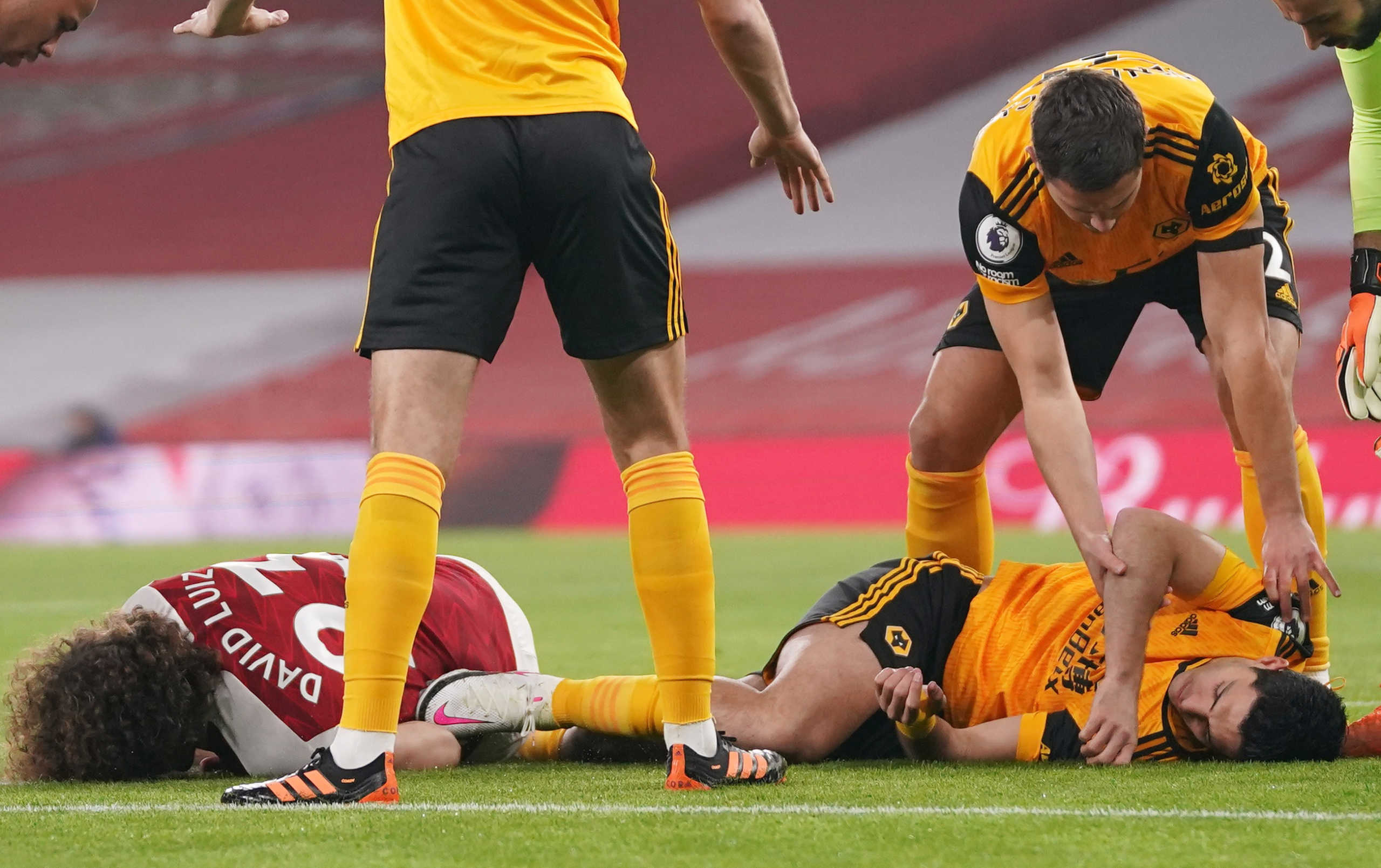 Soccer Football - Premier League - Arsenal v Wolverhampton Wanderers - Emirates Stadium, London, Britain - November 29, 2020 Arsenal's David Luiz and Wolverhampton Wanderers' Raul Jimenez after a head-on collision Pool via REUTERS