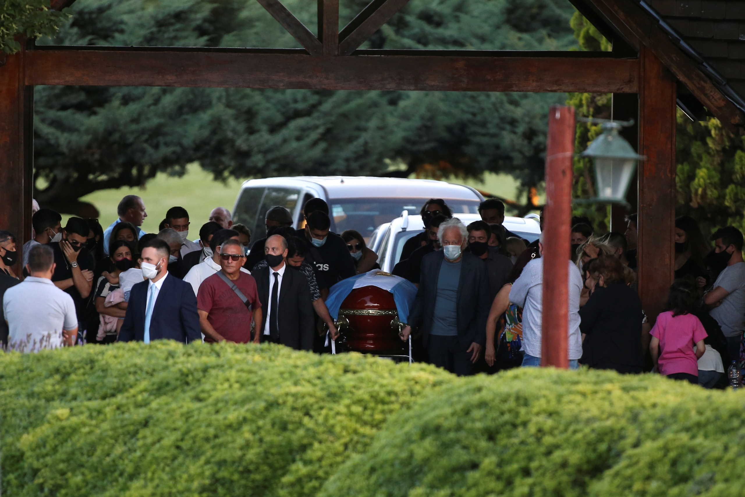 Friends and family carry the casket of soccer legend Diego Armando Maradona, at the cemetery in Buenos Aires, Argentina, November 26, 2020. REUTERS