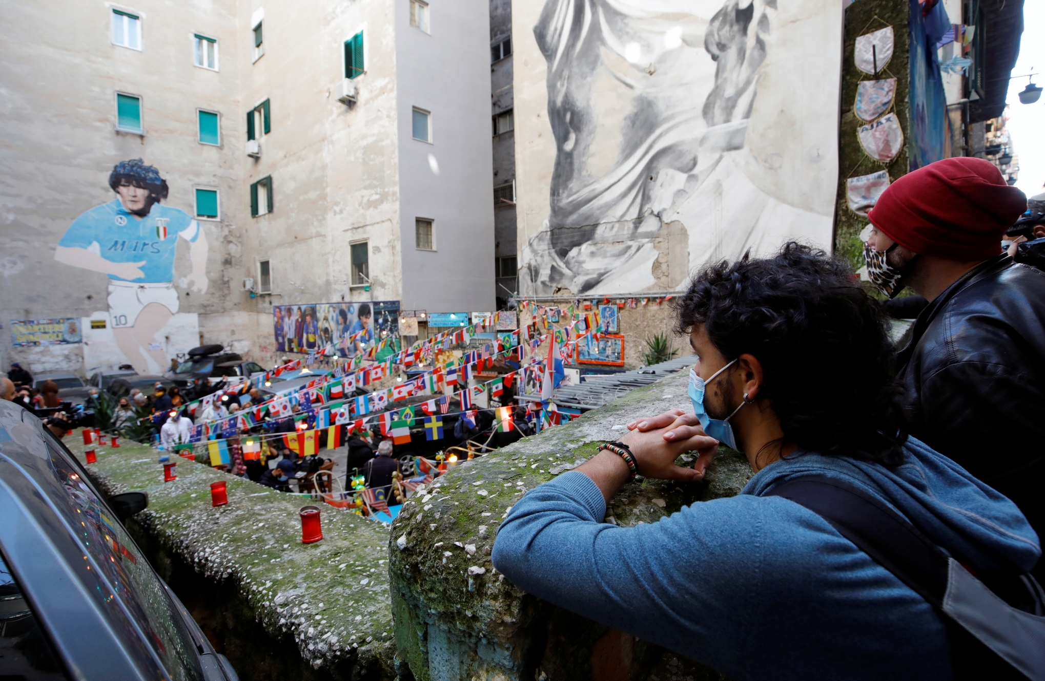 People gather to mourn the death of Argentine soccer legend Diego Maradona,who helped underdogs Napoli to the Italian title twice after he moved to the club in 1984, in Naples, Italy, November 26, 2020. REUTERS