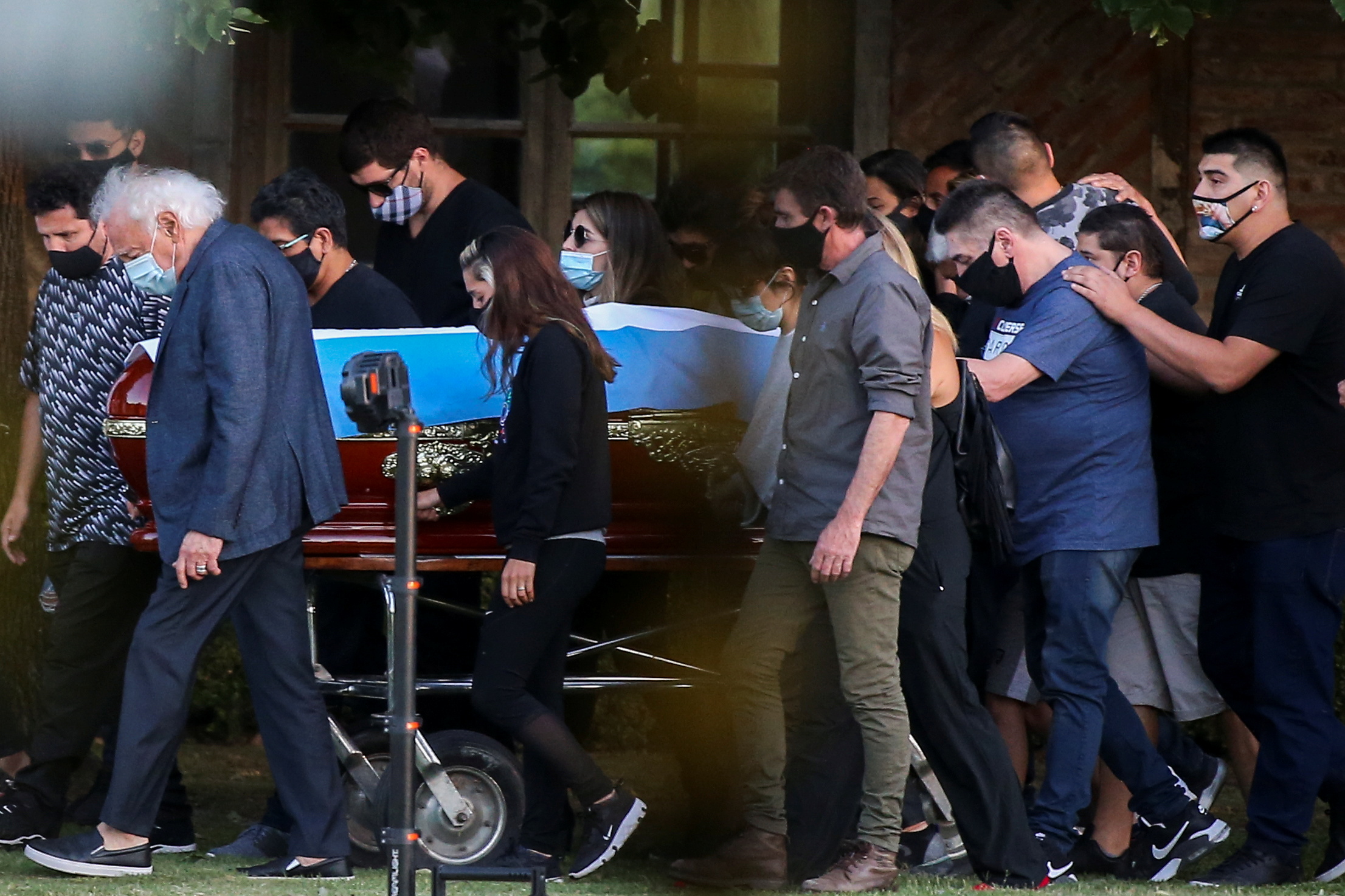 Friends and family carry the casket of soccer legend Diego Armando Maradona, at the cemetery in Buenos Aires, Argentina, November 26, 2020. REUTERS