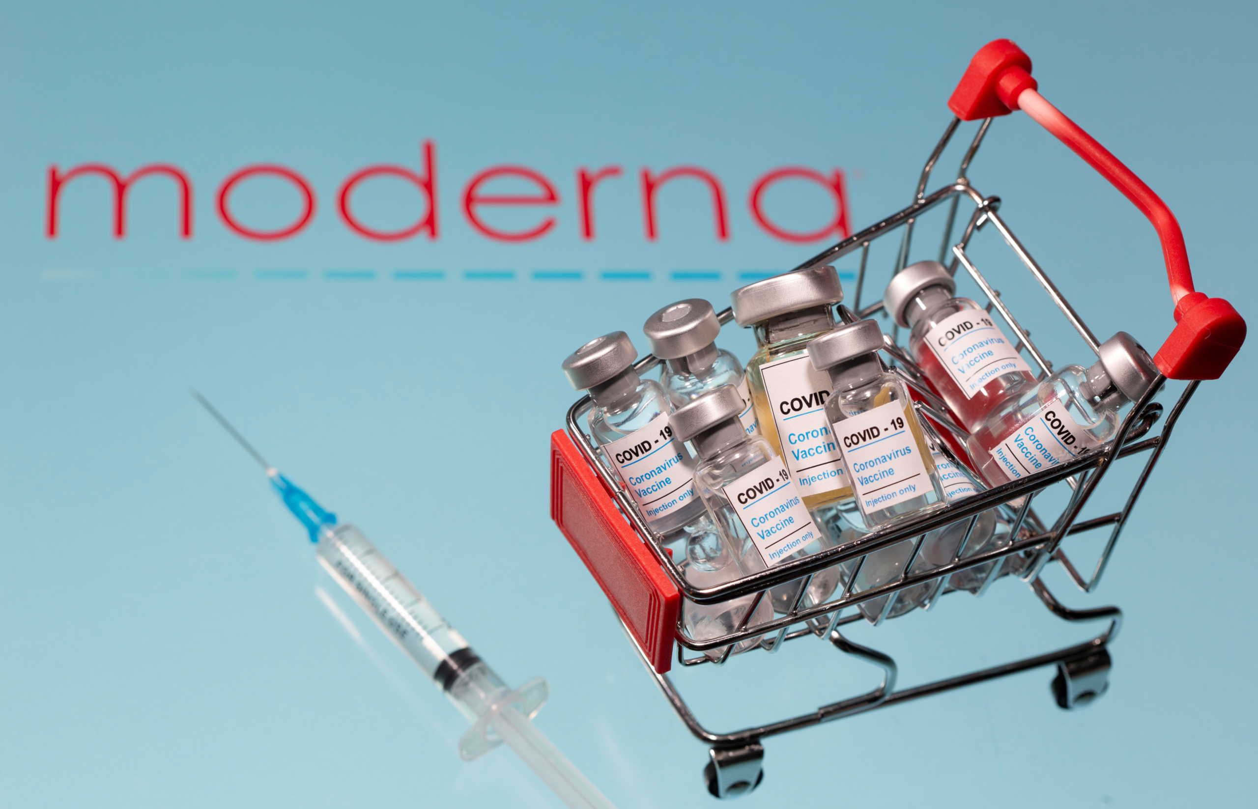 A small shopping basket filled with vials labeled "COVID-19 - Coronavirus Vaccine" and a medical sryinge are placed on a Moderna logo in this illustration taken November 29, 2020. Picture taken November 29, 2020. REUTERS