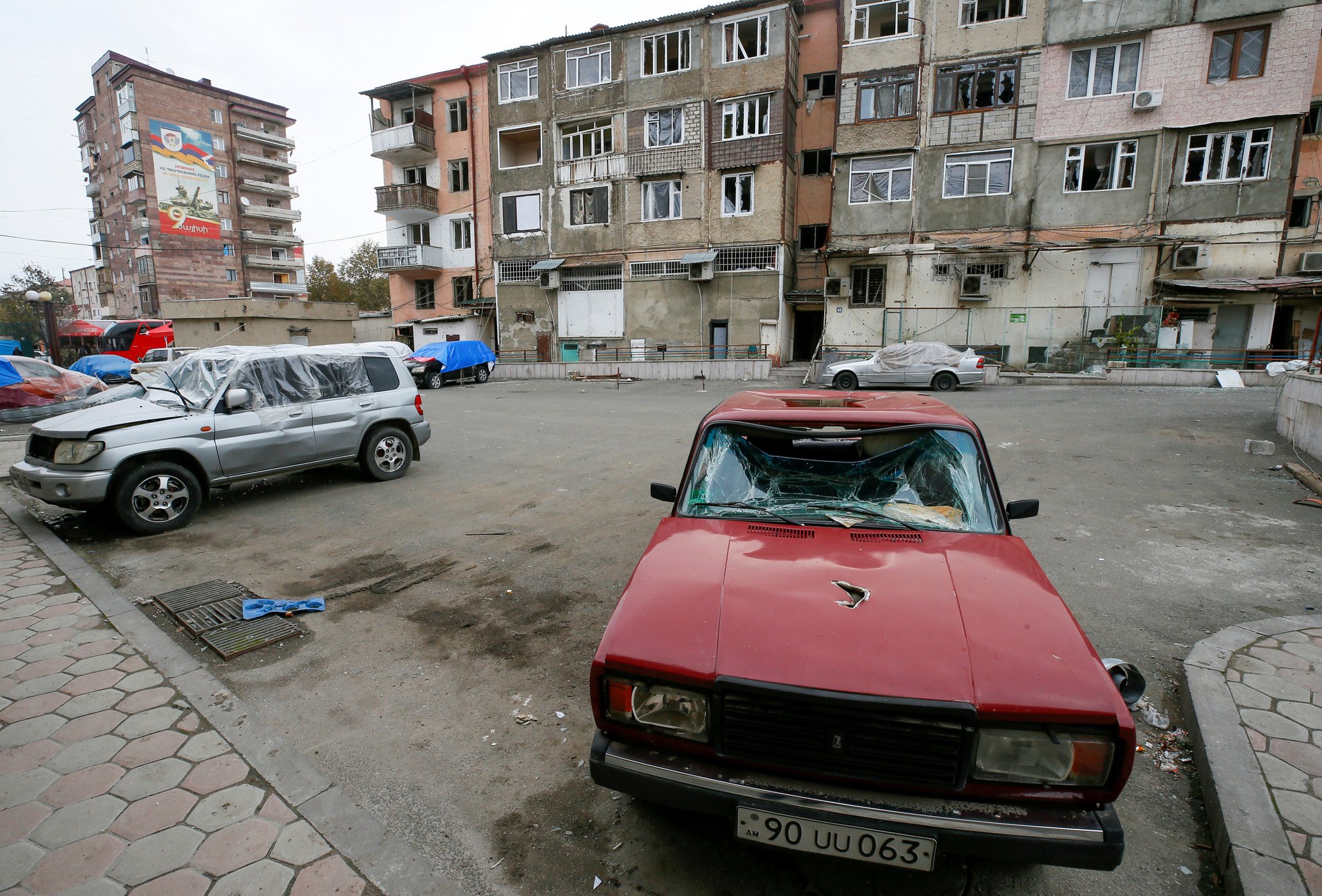 Cars damaged by recent shelling are seen in residential area in Stepanakert in the region of Nagorno-Karabakh, November 16, 2020. REUTERS
