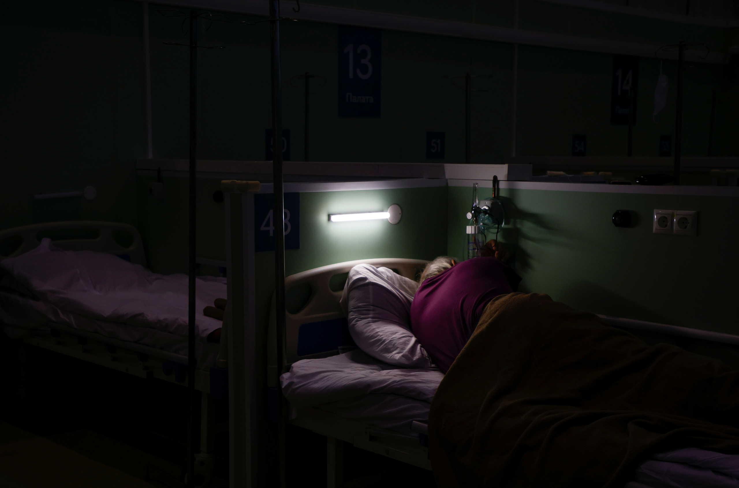 A patient is seen at the temporary hospital inside one of pavilions of Exhibition of Achievements of National Economy (VDNH), where patients suffering from the coronavirus disease (COVID-19) are treated, in Moscow, Russia November 17, 2020. Picture taken November 17, 2020. REUTERS