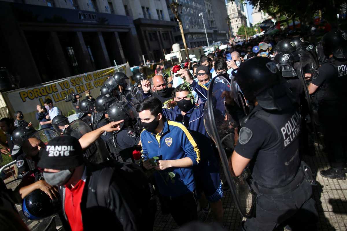 People wait in line outside the Casa Rosada presidential palace ahead of the wake of late soccer legend Diego Maradona, in Buenos Aires, Argentina November 26, 2020. REUTERS