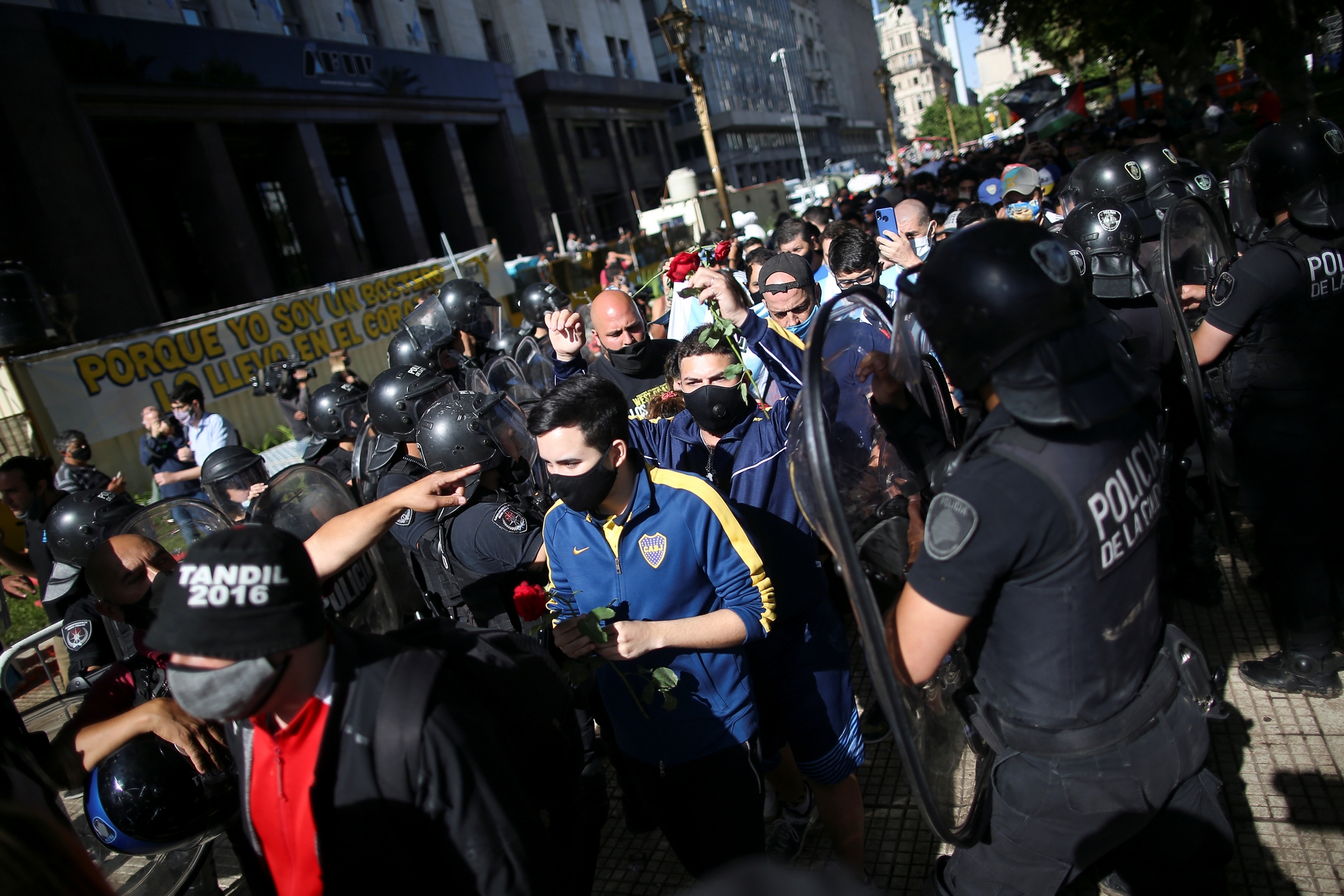 People wait in line outside the Casa Rosada presidential palace ahead of the wake of late soccer legend Diego Maradona, in Buenos Aires, Argentina November 26, 2020. REUTERS