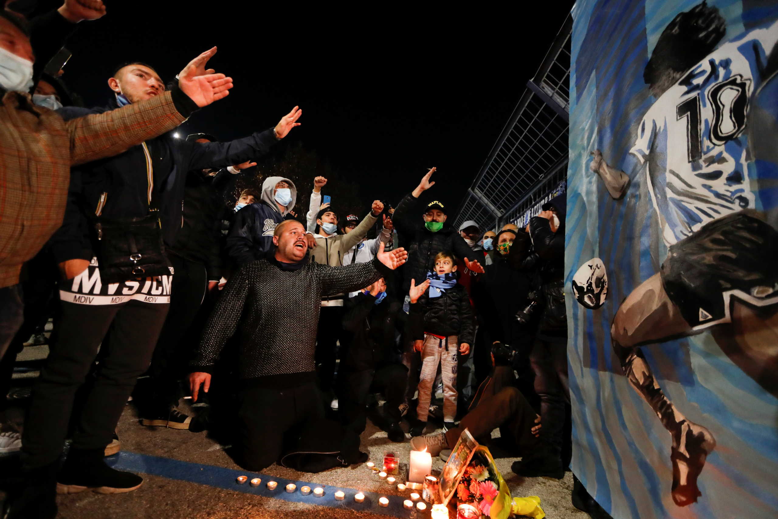 People gather to mourn the death of Argentine soccer legend Diego Maradona outside San Paolo stadium in Naples, Italy November 25, 2020. REUTERS
