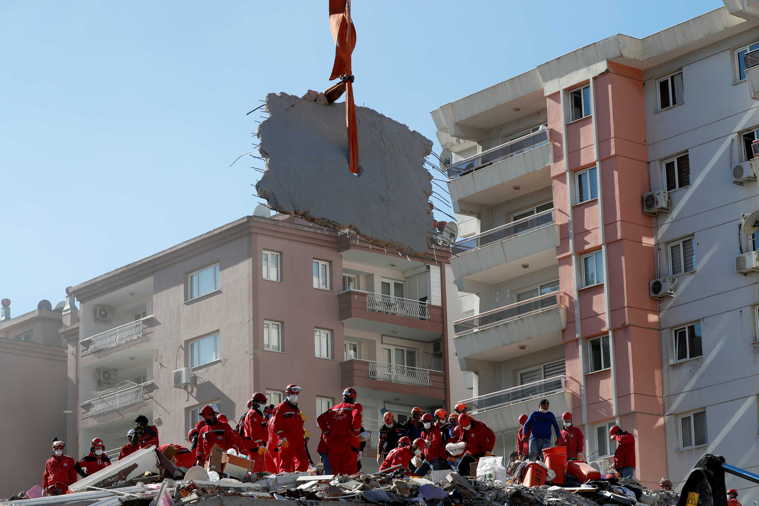 Rescue workers search for survivors at a collapsed building after an earthquake in the Aegean port city of Izmir, Turkey October 31, 2020. REUTERS