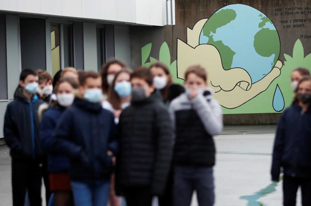 Schoolchildren wearing protective face masks, arrive to pay tribute to Samuel Paty, the French teacher who has beheaded on the streets of the Paris suburb of Conflans-Sainte-Honorine, at the Anne Franck college in Plescop, France, November 2, 2020. REUTERS