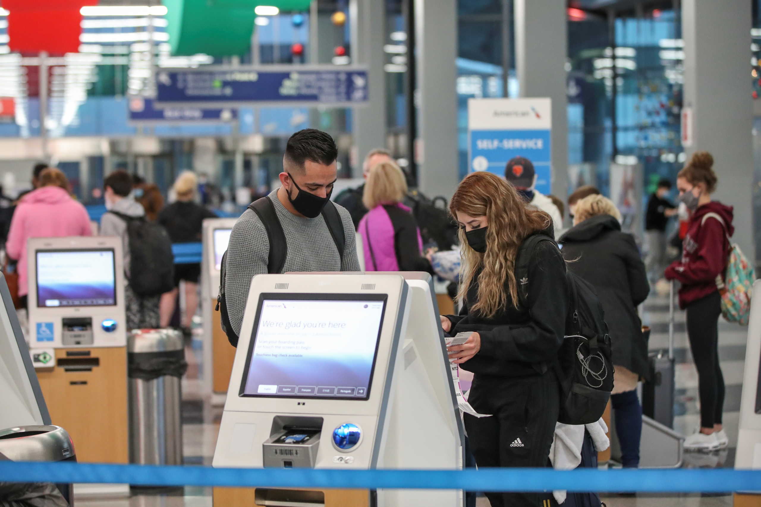 Travelers check-in for their flights at O'Hare International Airport ahead of the Thanksgiving holiday during the coronavirus disease (COVID-19) pandemic, in Chicago, Illinois, U.S. November 25, 2020. REUTERS