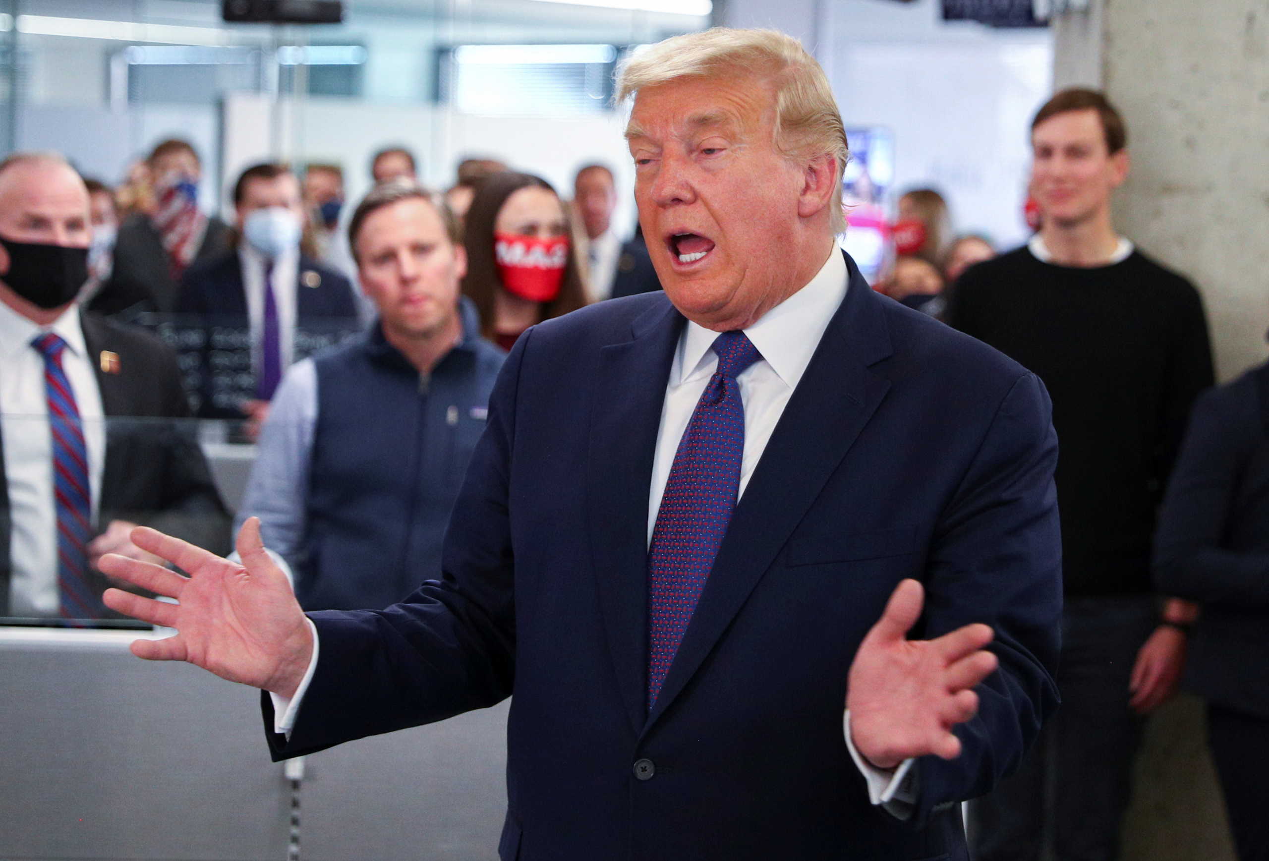 U.S. President Donald Trump greets staff members while his son in-law and senior advisor Jared Kushner looks on as he visits his presidential campaign headquarters on Election Day in nearby Arlington, Virginia, U.S., November 3, 2020. REUTERS