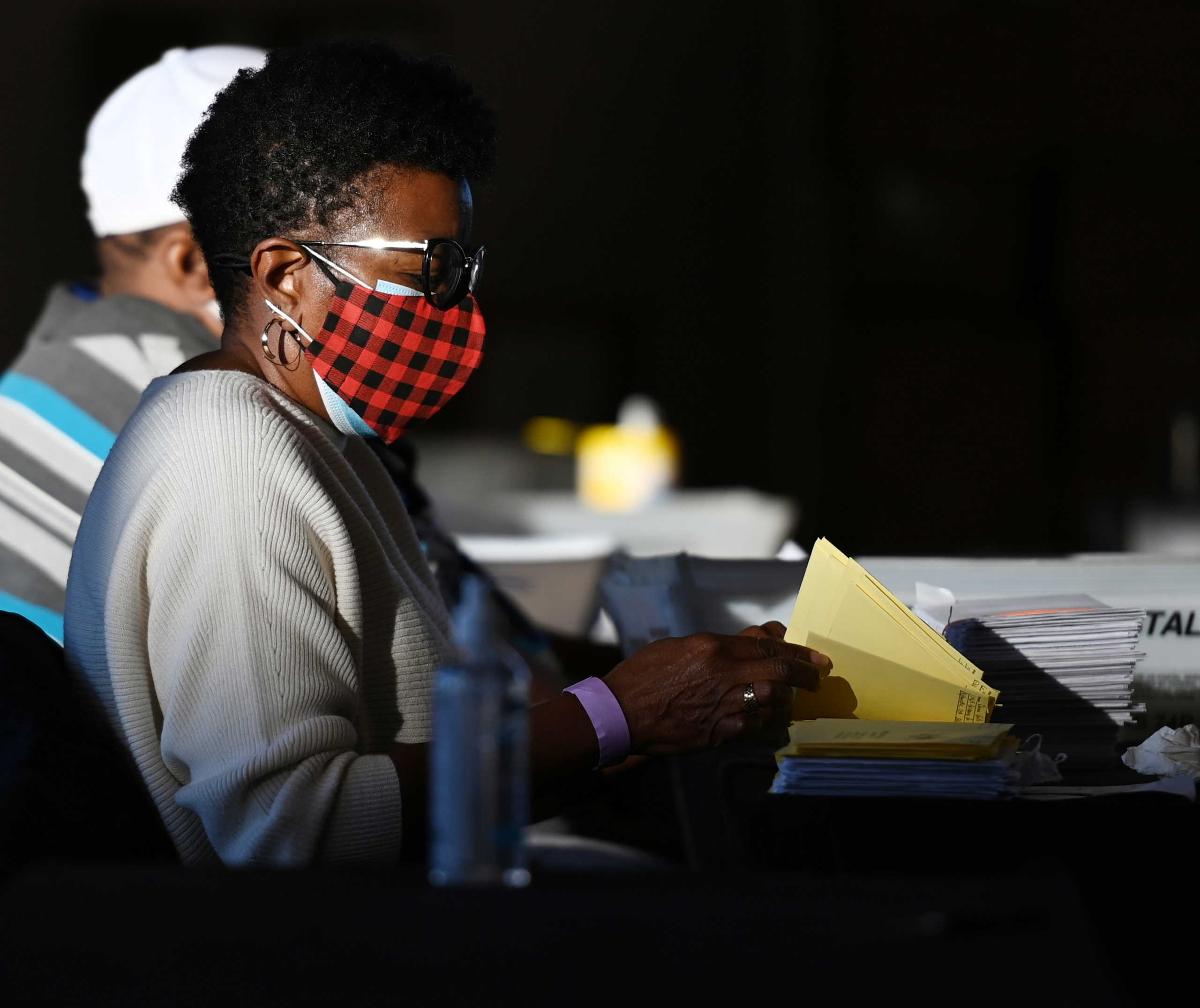 An employee of the Fulton County Board of Registration and Elections processes ballots in Atlanta, Georgia U.S., November 5, 2020. REUTERS