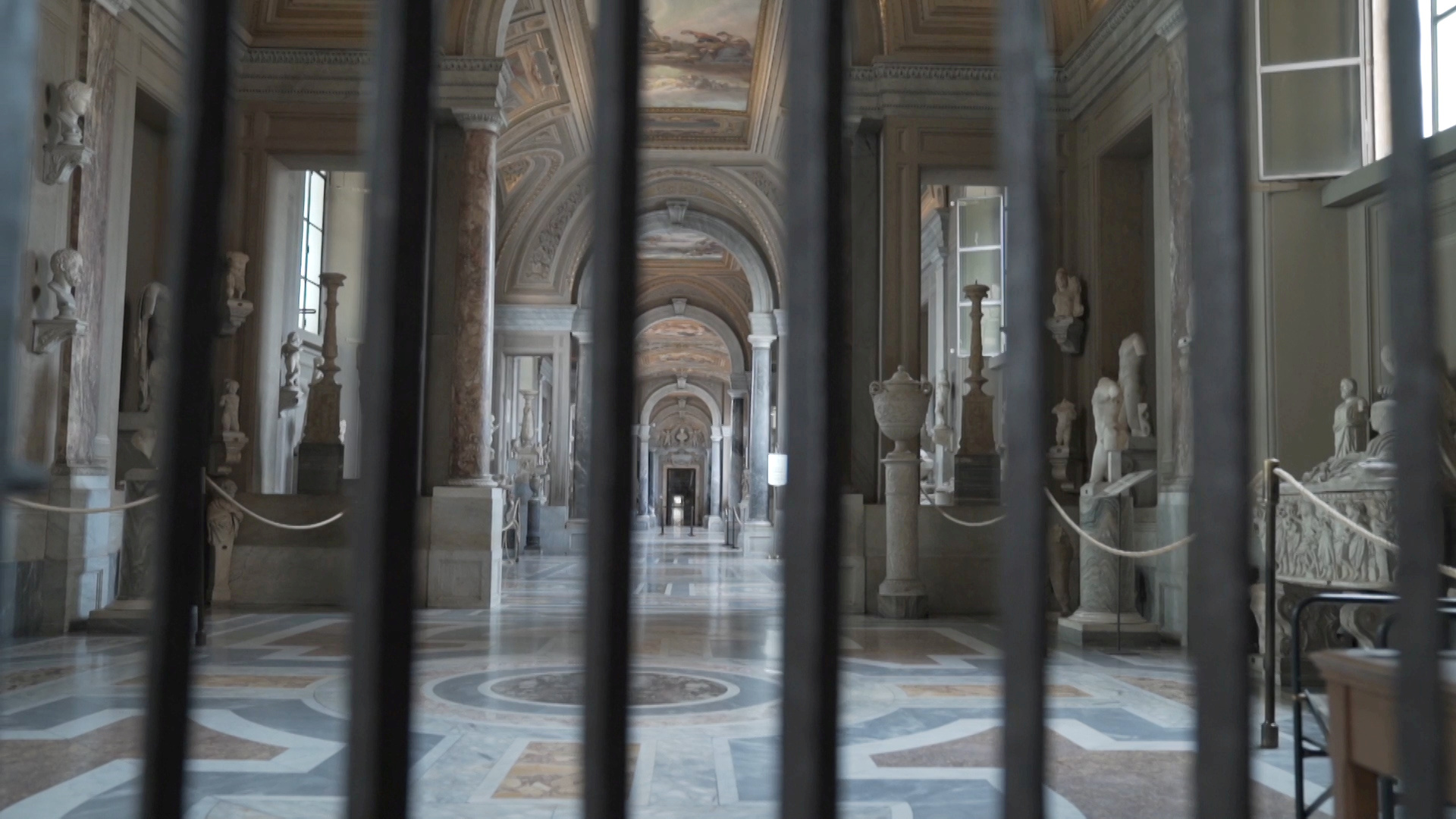 FILE PHOTO: An empty corridor inside Vatican Museums is seen through bars as staff prepare for reopening on June 1 with new social distancing and hygiene rules after months of closure due to a spread of the coronavirus disease (COVID-19) in this still image taken from an undated video in Vatican City. Musei Vaticani