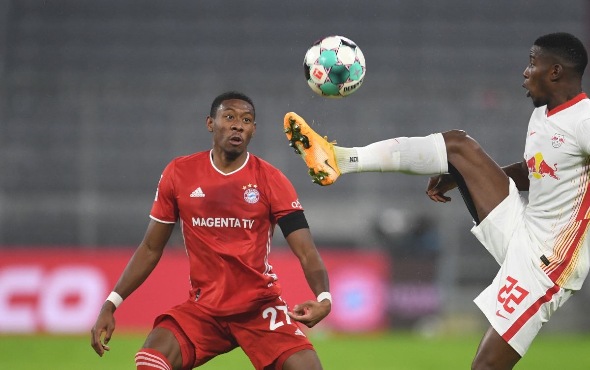 Soccer Football - Bundesliga - Bayern Munich v RB Leipzig - Allianz Arena, Munich, Germany - December 5, 2020 Bayern Munich's David Alaba in action with RB Leipzig's Nordi Mukiele Pool via REUTERS