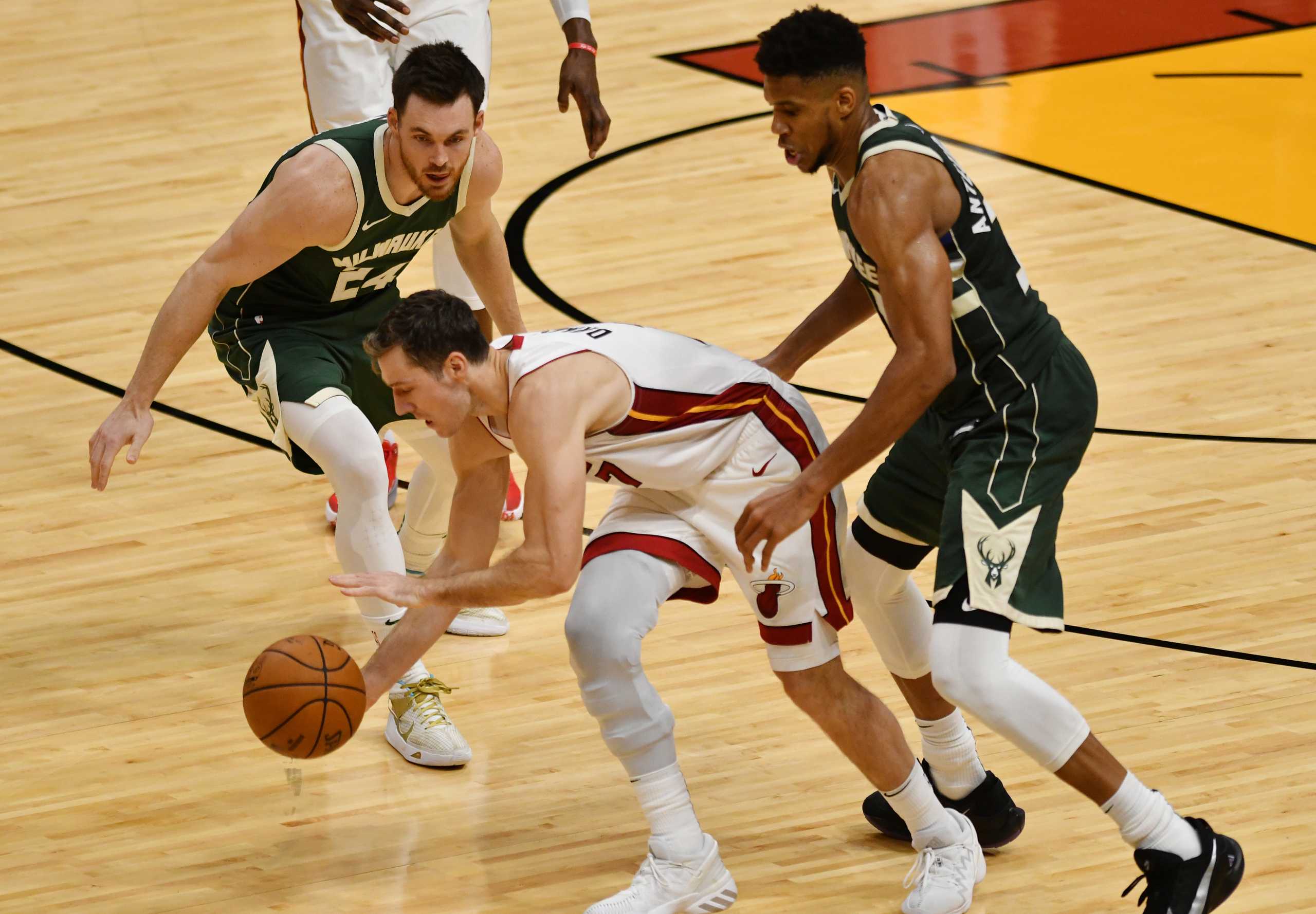 Dec 30, 2020; Miami, Florida, USA; Milwaukee Bucks guard Pat Connaughton (24) and forward Giannis Antetokounmpo (34) pressure Miami Heat guard Goran Dragic (7) in the fourth quarter at American Airlines Arena. Mandatory Credit: Jim Rassol-USA TODAY Sports