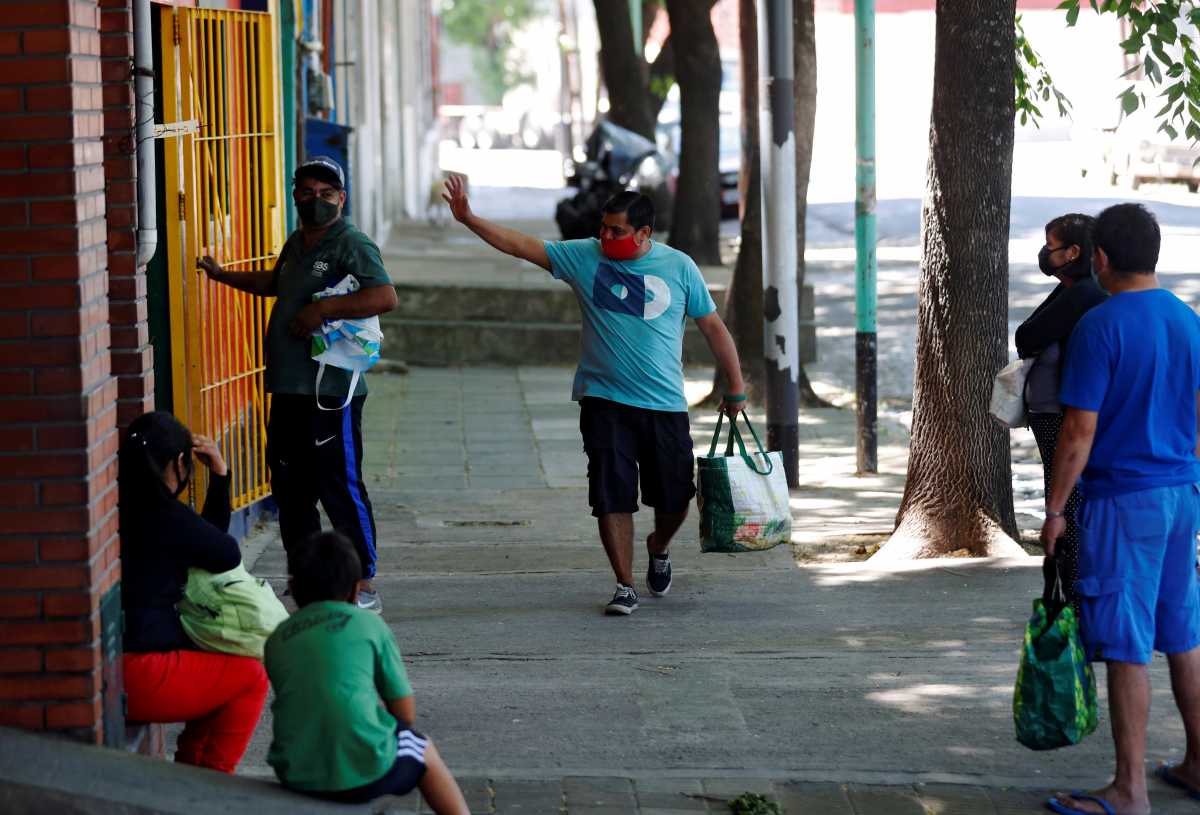 Gustavo Delgado, 52, who lost his job during the coronavirus disease (COVID-19) outbreak, waves to the volunteers at a soup kitchen, where he collects food every day for his family, in Buenos Aires, Argentina November 16, 2020. Picture taken November 16, 2020. REUTERS