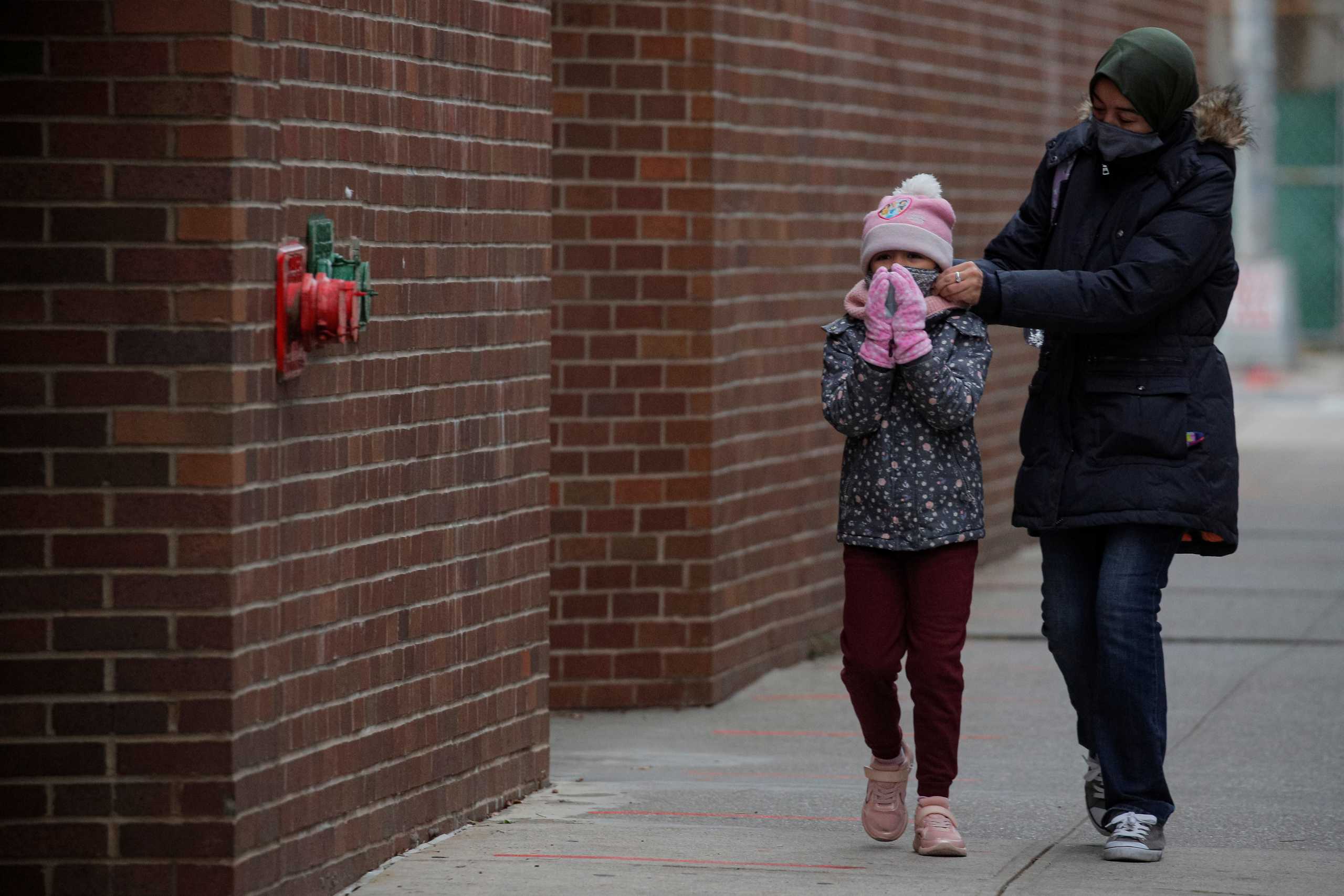 A student arrives as New York City's public schools return for in-person learning, as the global outbreak of the coronavirus disease (COVID-19) continues, at P.S. 506 in Brooklyn, New York, U.S., December 7, 2020.  REUTERS
