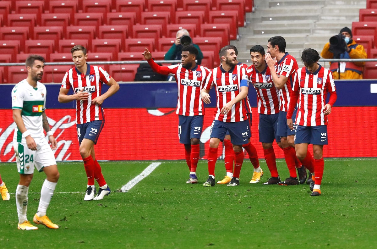 Soccer Football - La Liga Santander - Atletico Madrid v Elche - Wanda Metropolitano, Madrid, Spain - December 19, 2020 Atletico Madrid's Luis Suarez celebrates scoring their first goal with teammates REUTERS
