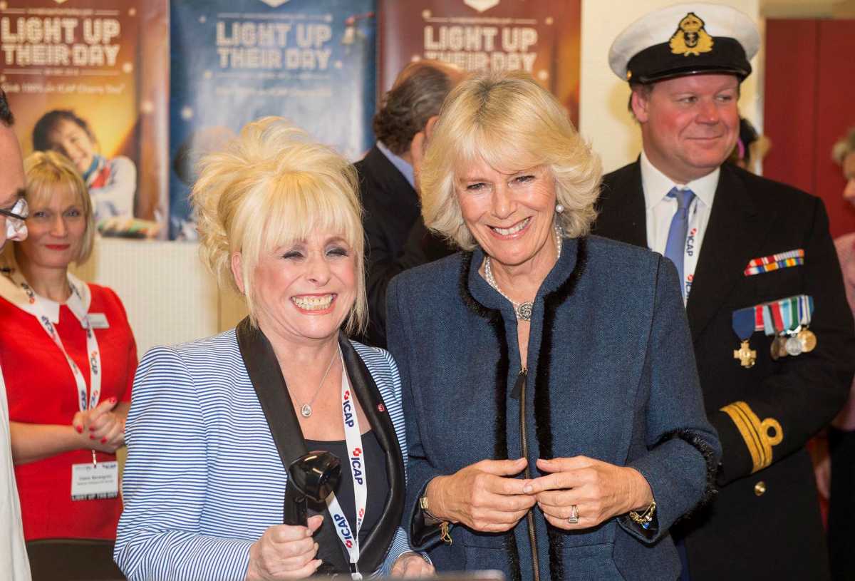 FILE PHOTO: Britain's Camilla, Duchess of Cornwall and actress Barbara Windsor pose for a photograph at the annual ICAP charity day in the City of London December 3, 2013.  REUTERS