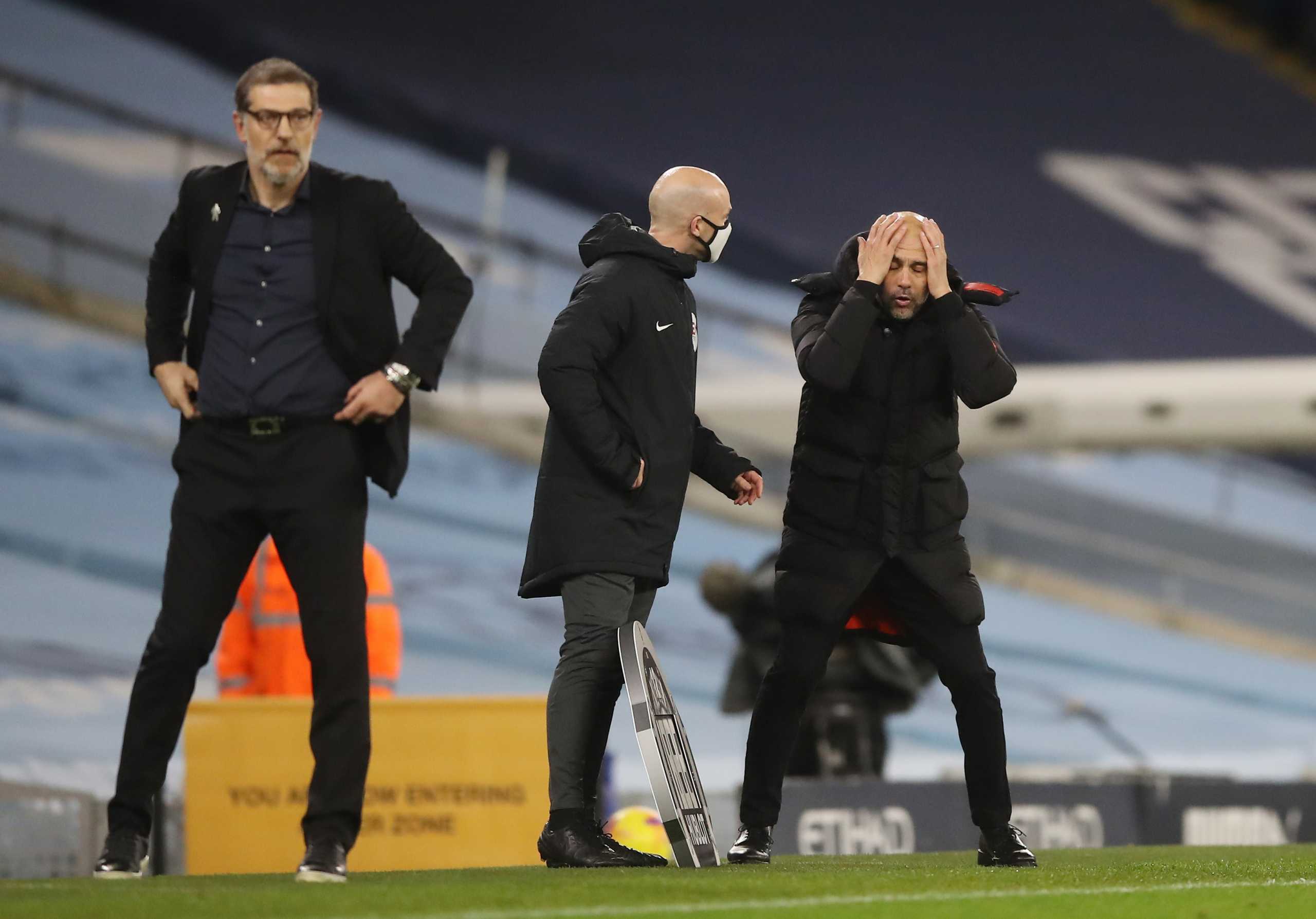 Soccer Football - Premier League - Manchester City v West Bromwich Albion - Etihad Stadium, Manchester, Britain - December 15, 2020 Manchester City manager Pep Guardiola reacts as West Bromwich Albion manager Slaven Bilic looks on Pool via REUTERS