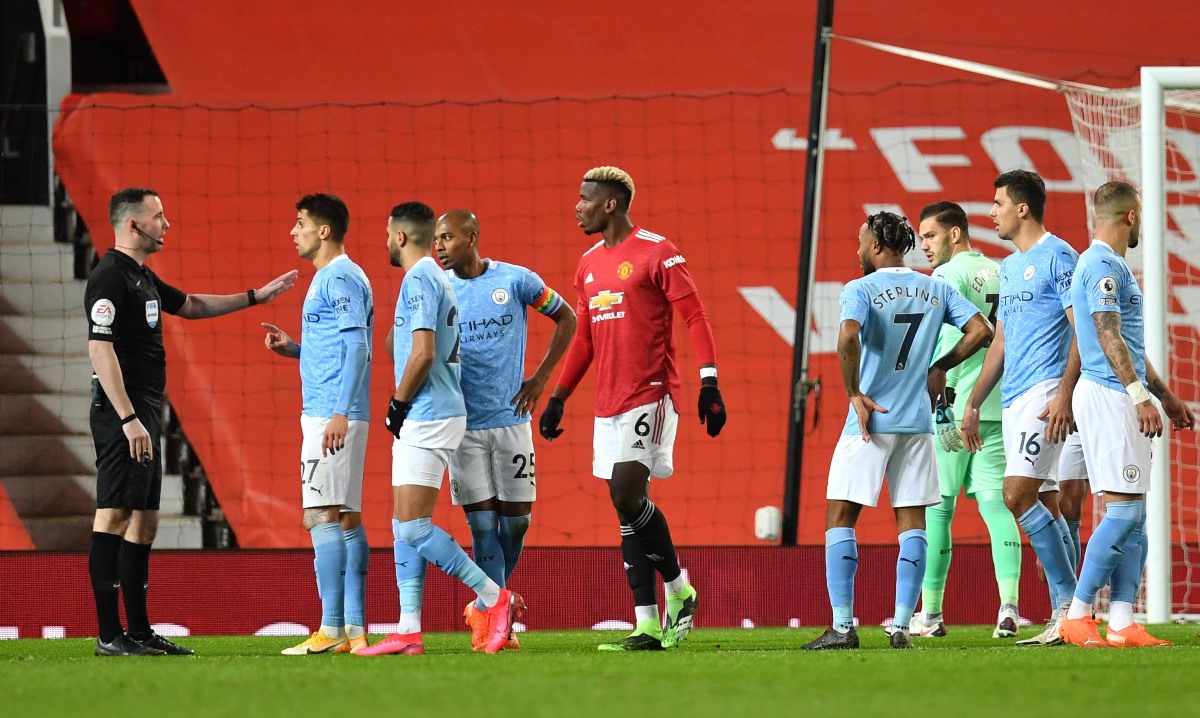 Soccer Football - Premier League - Manchester United v Manchester City - Old Trafford, Manchester, Britain - December 12, 2020 Manchester City's Joao Cancelo and teammates remonstrate with referee Chris Kavanagh Pool via REUTERS