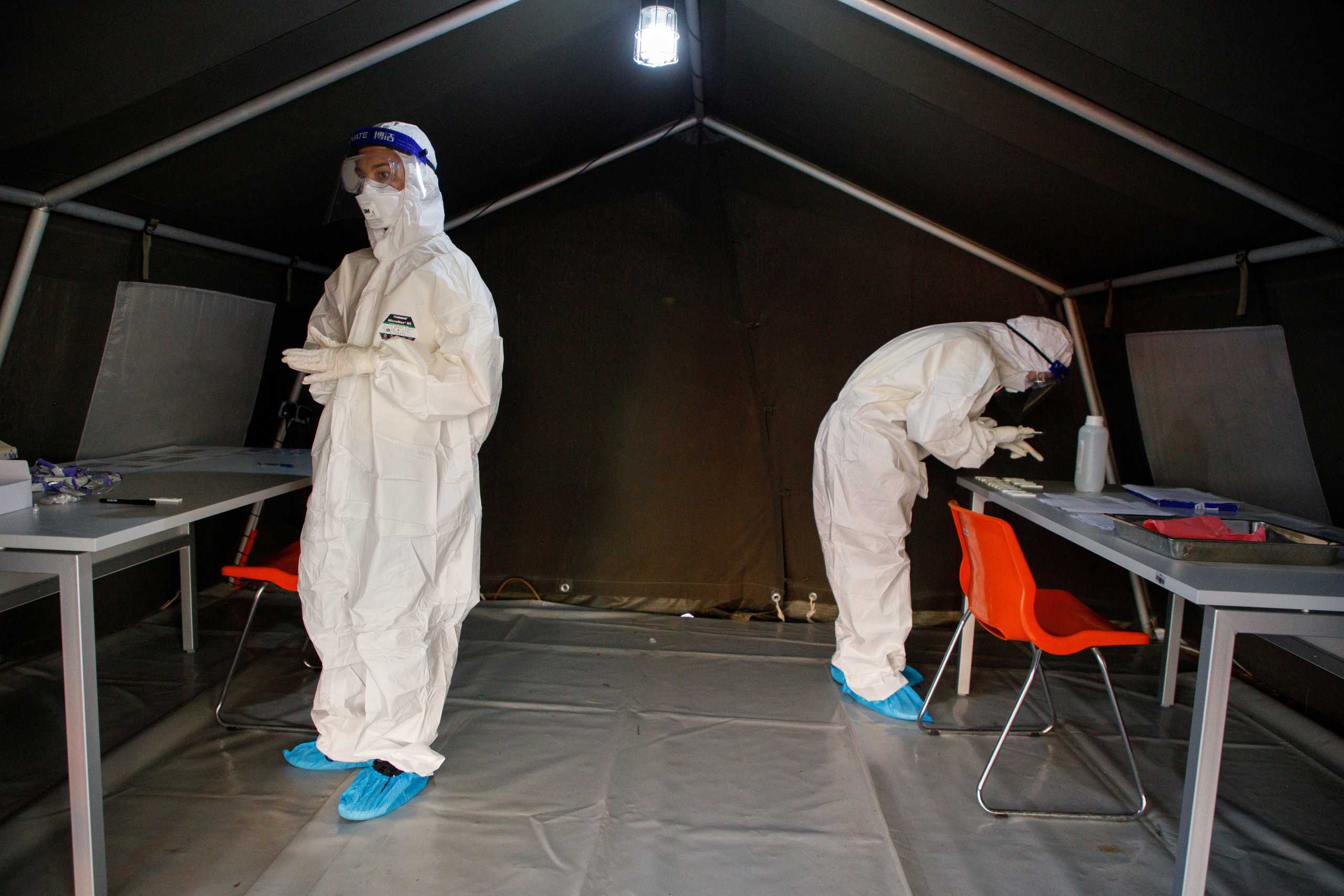 Medical workers examine antigen tests as they prepare to check 60,000 people in Zagreb during the coronavirus pandemic, in Croatia, November 23, 2020. REUTERS