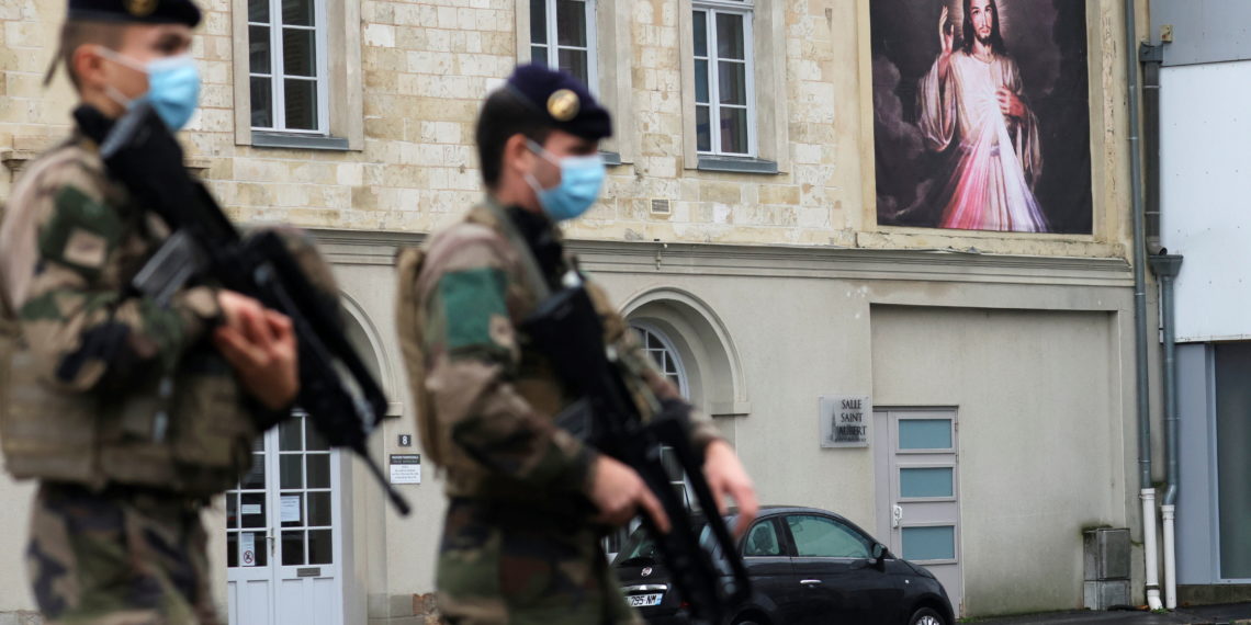 French soldiers patrol near the Saint Gery church in Cambrai as the country has raised the security alert for its territory to the highest level after the knife attack in the city of Nice, France, November 1, 2020. REUTERS