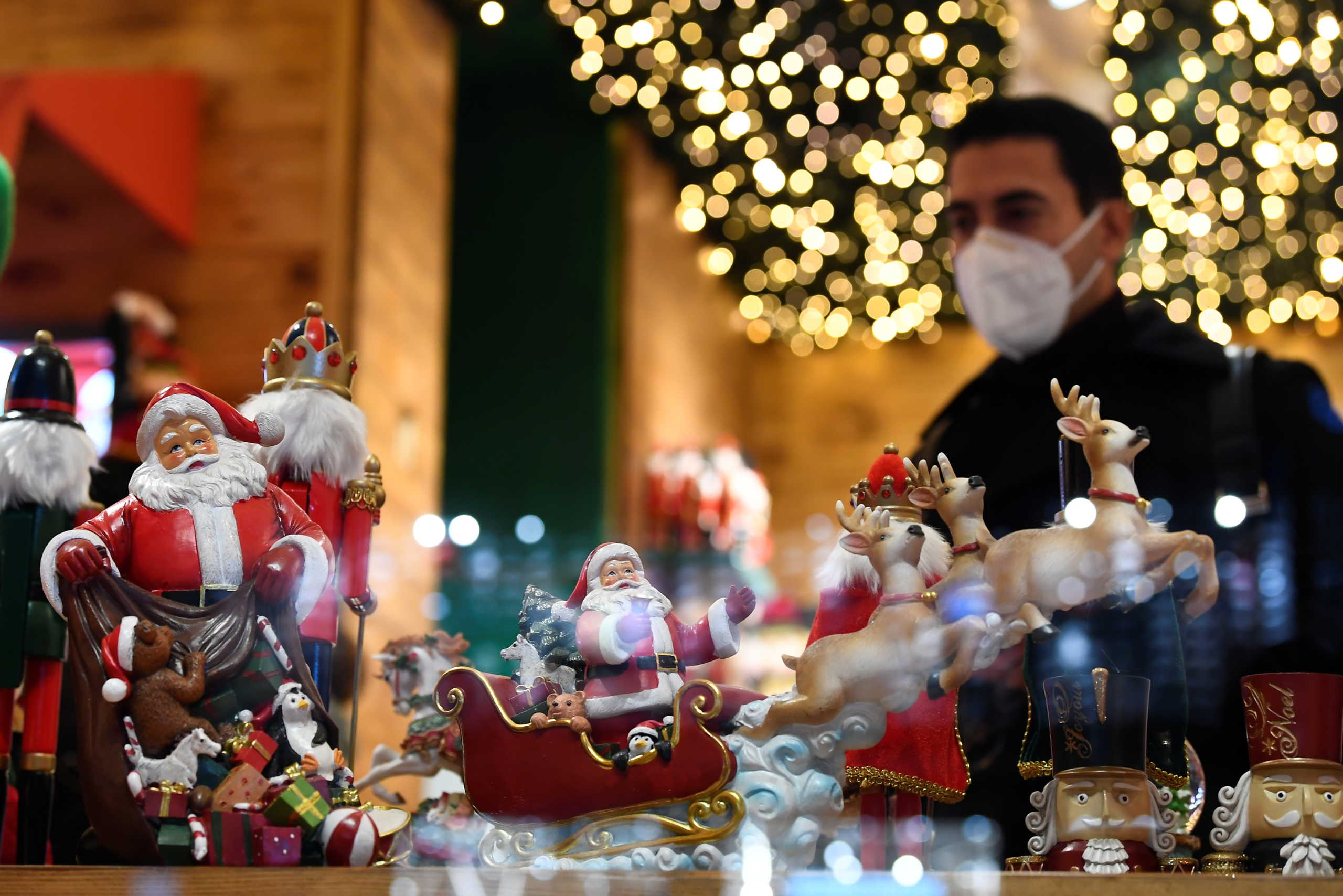Christmas decorations are on display as people go shopping after Lombardy was downgraded from a red to an orange zone, loosening coronavirus disease (COVID-19) restrictions including allowing non-essential shops to re-open ahead of Christmas, in Milan, Italy, December 1, 2020. REUTERS