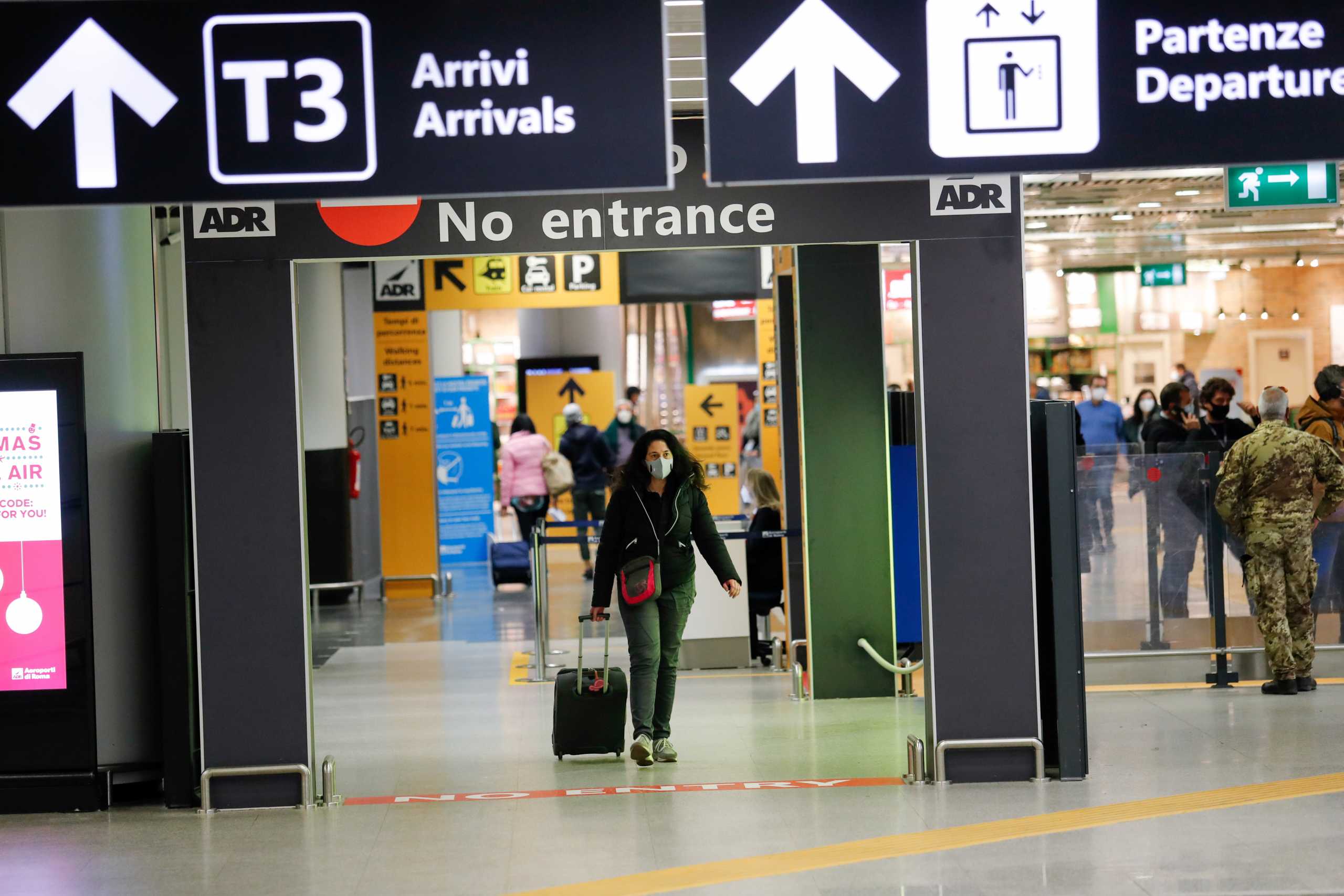 A passenger walks at Fiumicino airport after the Italian government announced all flights to and from the UK will be suspended over fears of a new strain of the coronavirus, amid the spread of the coronavirus disease (COVID-19), in Rome, Italy, December 20, 2020. REUTERS