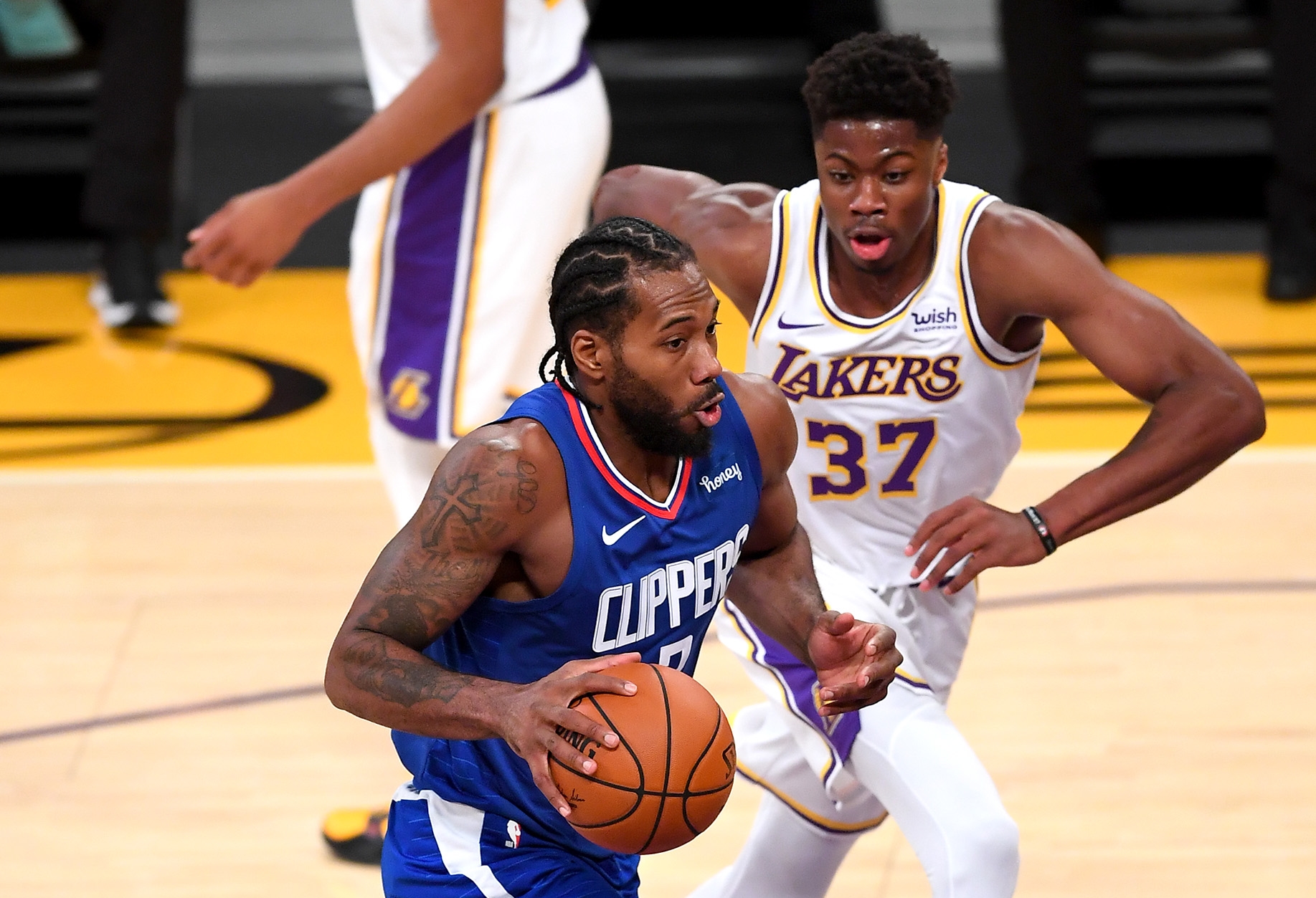 Dec 11, 2020; Los Angeles, California, USA;   Los Angeles Lakers forward Kostas Antetokounmpo (37) guards Los Angeles Clippers forward Kawhi Leonard (2) as he heads down court in the first half of the game at Staples Center. Mandatory Credit: Jayne Kamin-Oncea-USA TODAY Sports