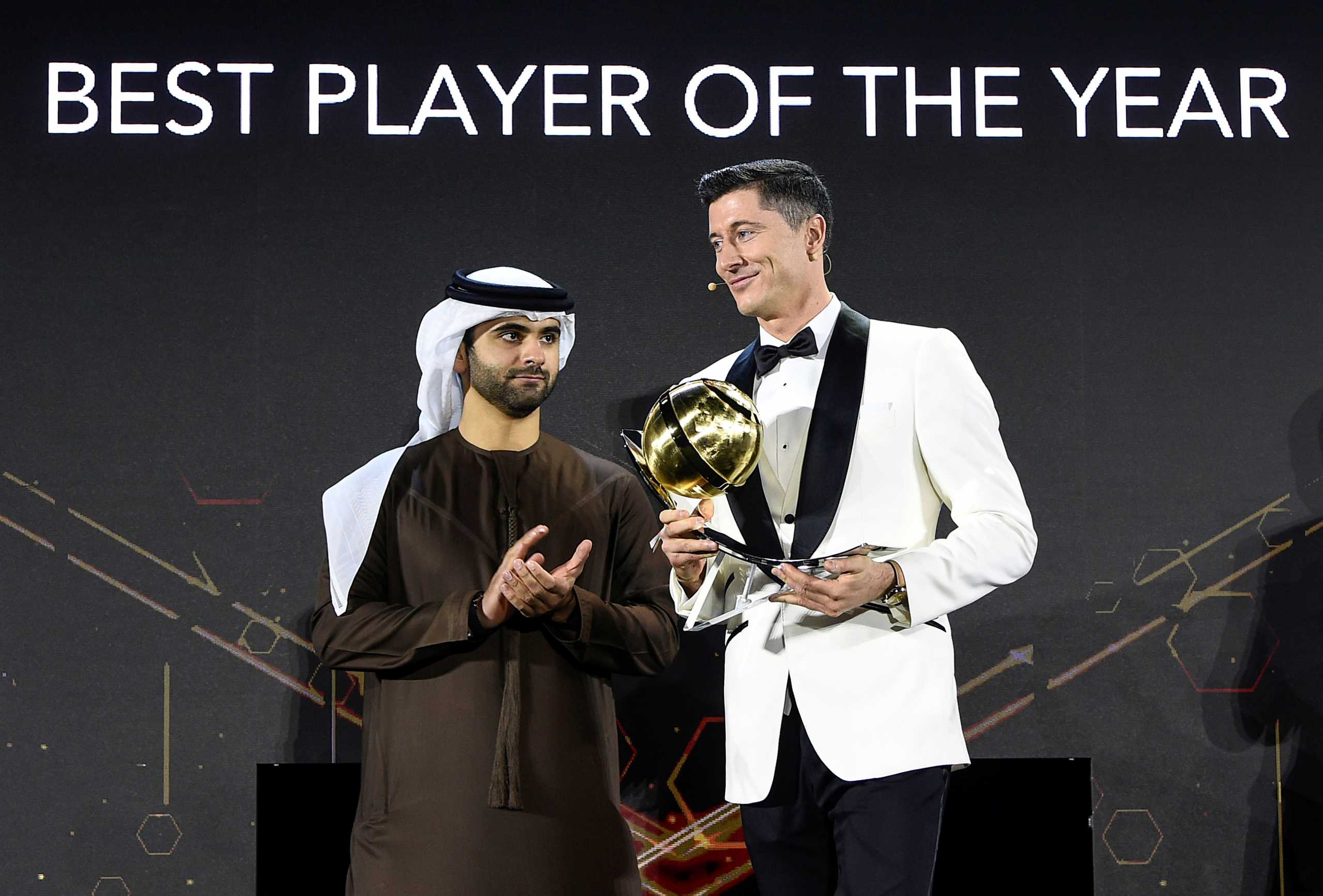 Soccer Football - Globe Soccer Awards - Armani hotel, Burj Khalifa, Dubai, United Arab Emirates - December 27, 2020 Bayern Munich's Robert Lewandowski is presented a trophy by Sheikh Hamdan Bin Mohammed Bin Rashid Al Maktoum after winning the Best player of the Year award LaPresse