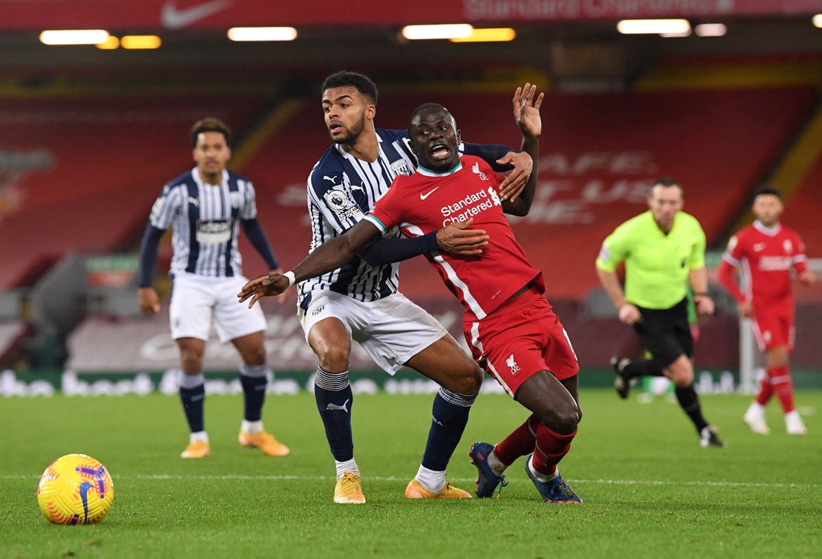 Soccer Football - Premier League - Liverpool v West Bromwich Albion - Anfield, Liverpool, Britain - December 27, 2020 Liverpool's Sadio Mane in action with West Bromwich Albion's Darnell Furlong Pool via REUTERS