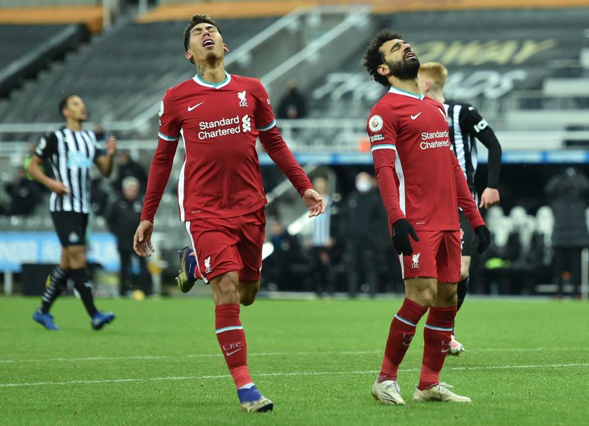 Soccer Football - Premier League - Newcastle United v Liverpool - St James' Park, Newcastle, Britain - December 30, 2020 Liverpool's Mohamed Salah and Roberto Firmino react Pool via REUTERS